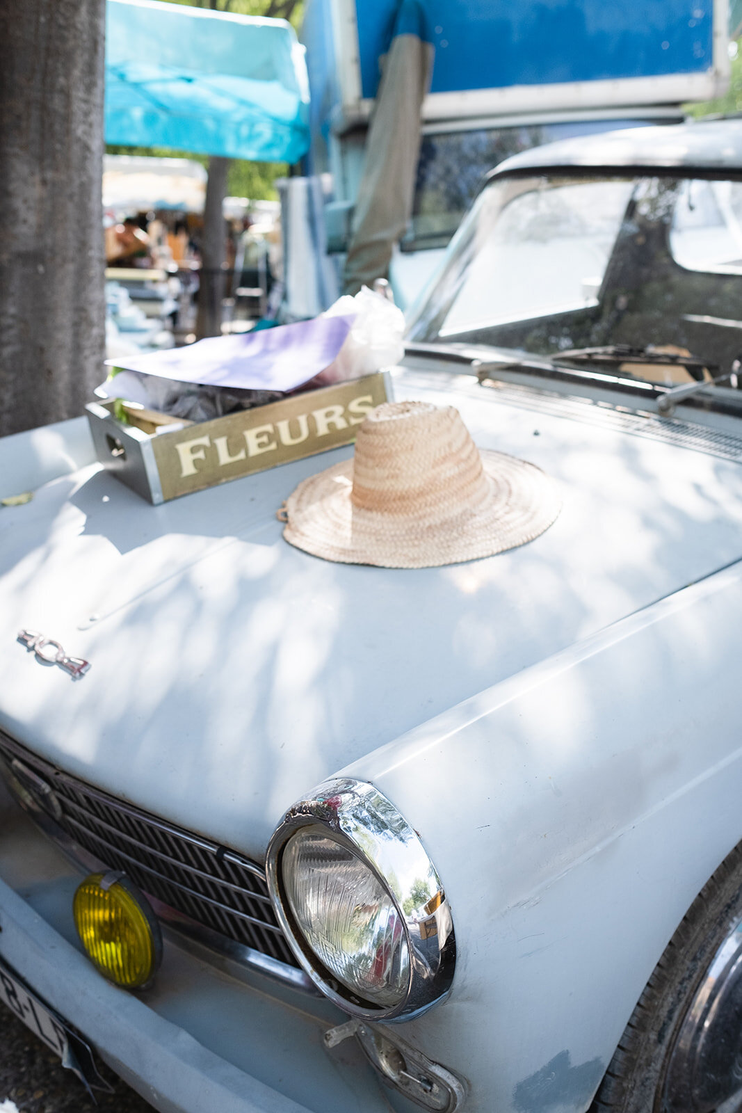 Fleur box and a straw hat on a vintage car in the South of France