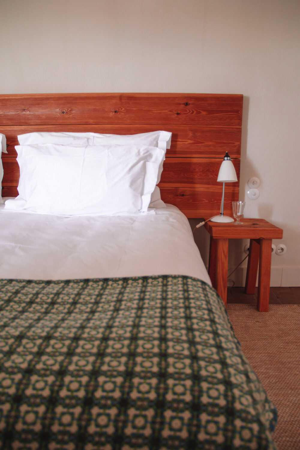 Locally made wool blankets lay at the end of each bed