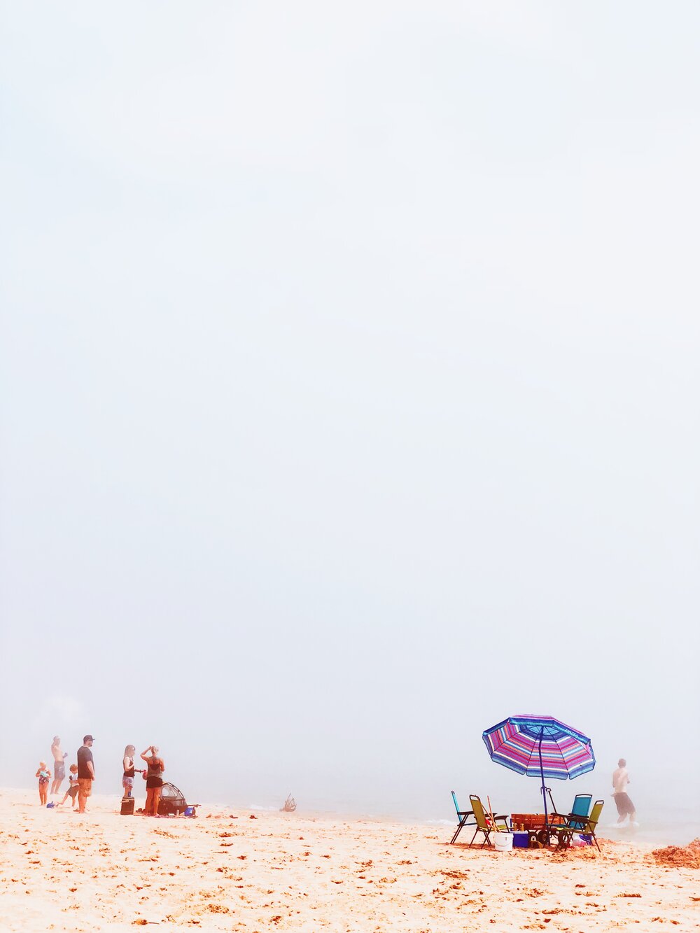 When the cold water of Lake Michigan meets a hot, humid day, the beach become foggy