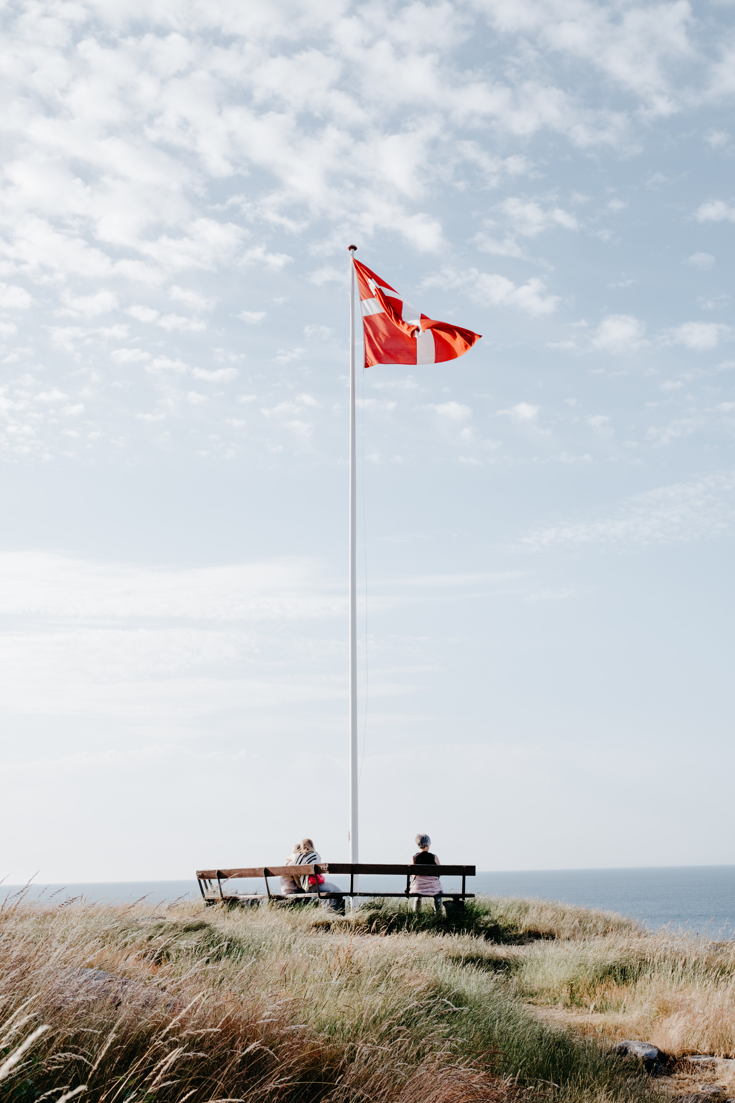 The Danish flag soaring over the coast