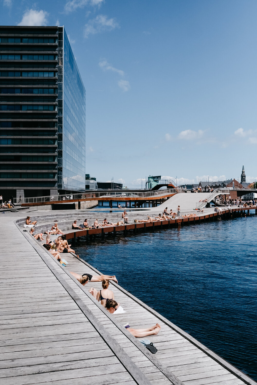 Residents line a modern dock for urban swimming in Denmark