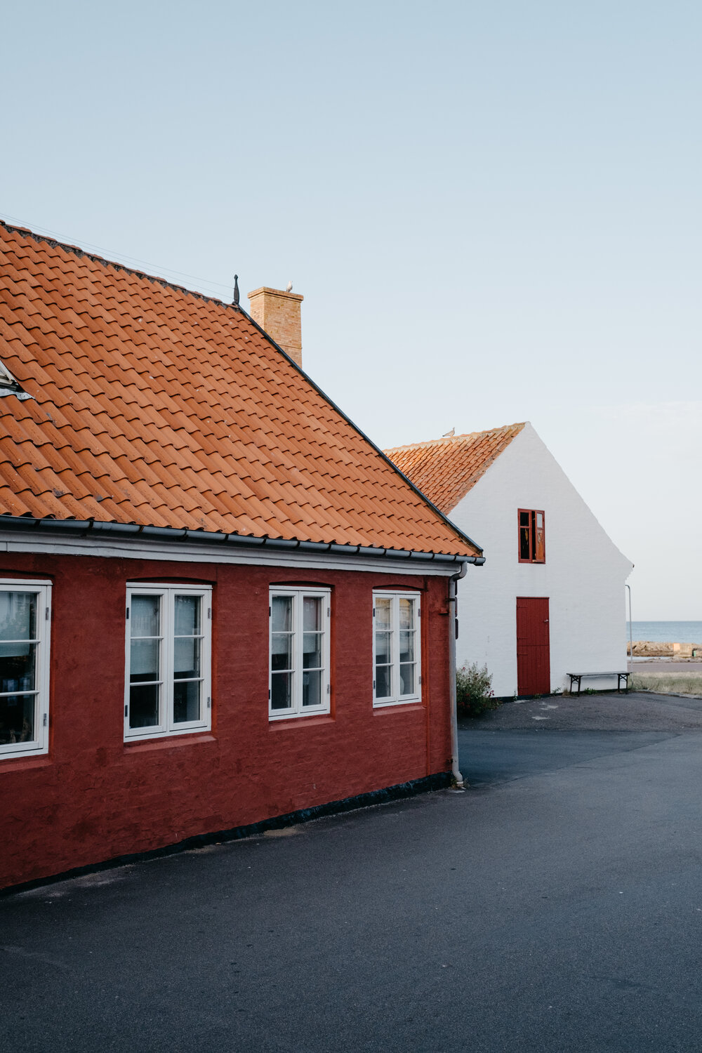 Red and white buildings with tile roofs outside of Copenhagen