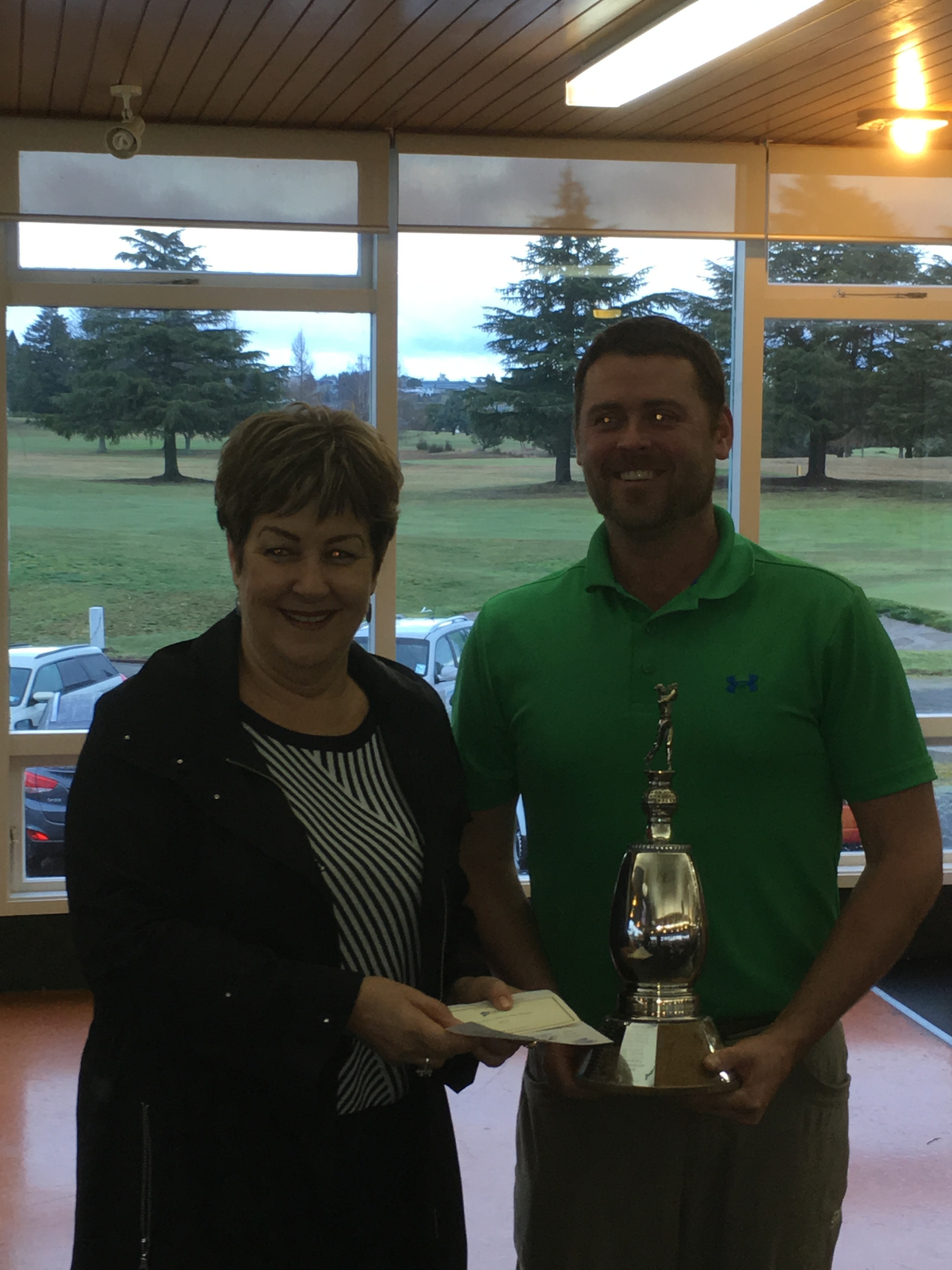 the Mens and Womens winners being presented with their trophies by Rosie Harvey, Co-owner of Harcourts. Taupo