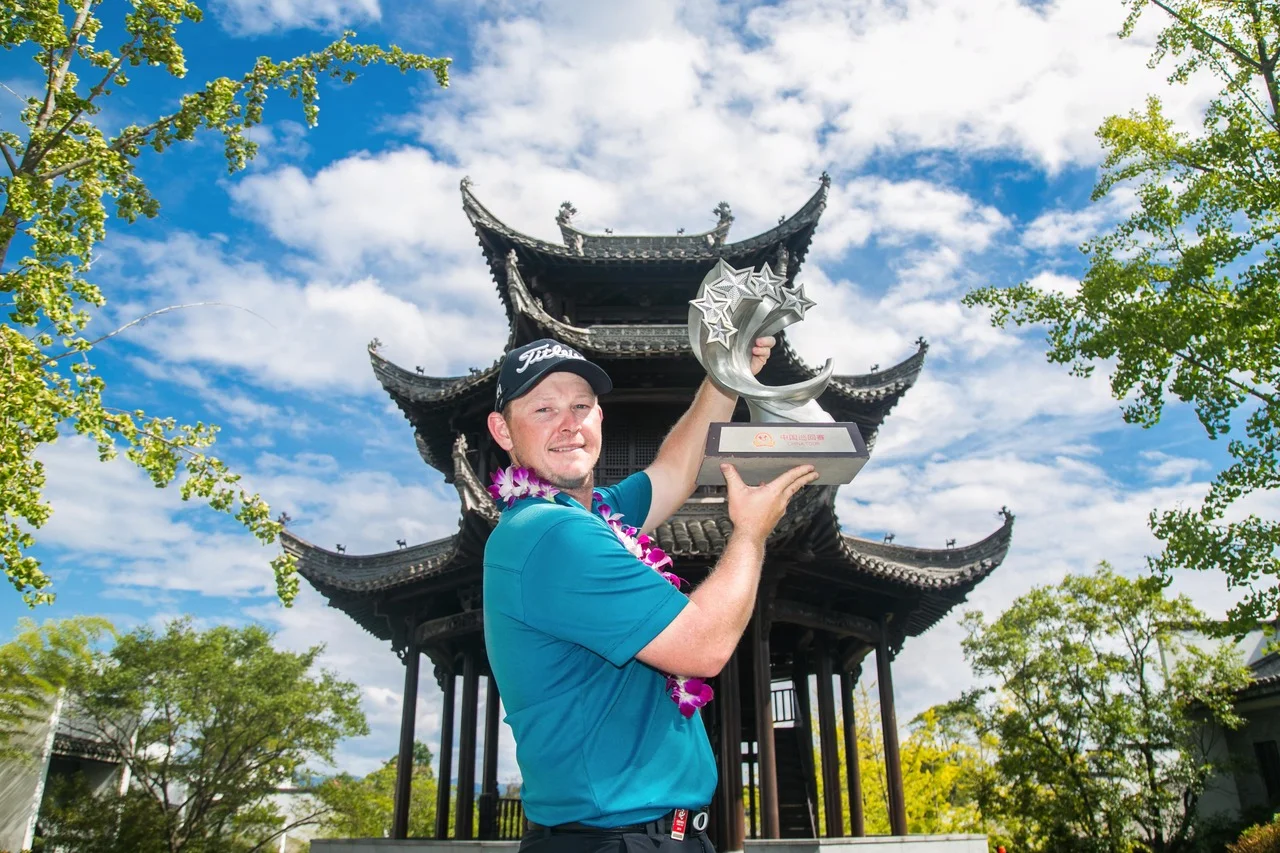 Tauranga golfer Kieran Muir holds aloft his trophy following his first win on the China Tour. Photo credit: China Tour.