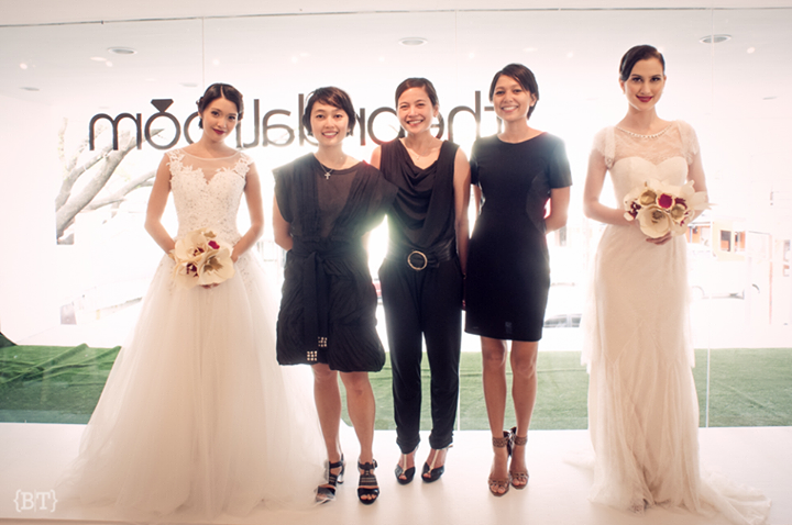 Live mannequin models holding paper flower bouquets, standing alongside the owners of The Bridal Room, sisters Mica Tantuico, Anna Tantuico, and Raisa Vargas. 