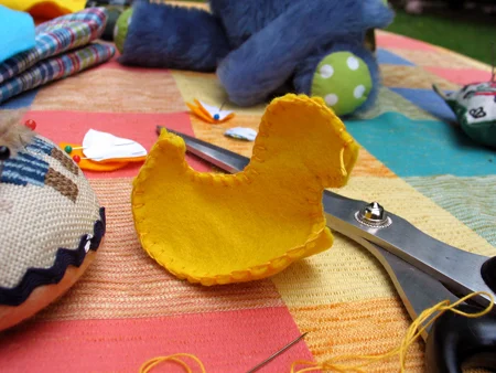 Step 3. Put the tummy in. Blanketstitch from tail* to beak ** and then from chest to tail. Don't forget to stuff the body before you close it.