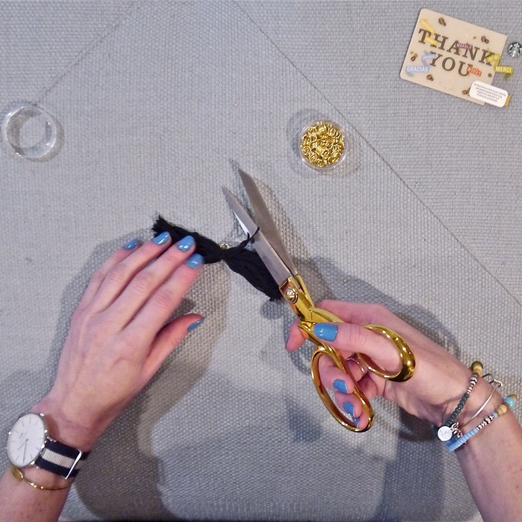 Cut the loops of the folded thread open. Don't shorten them, these threads will become part of the tassel. 