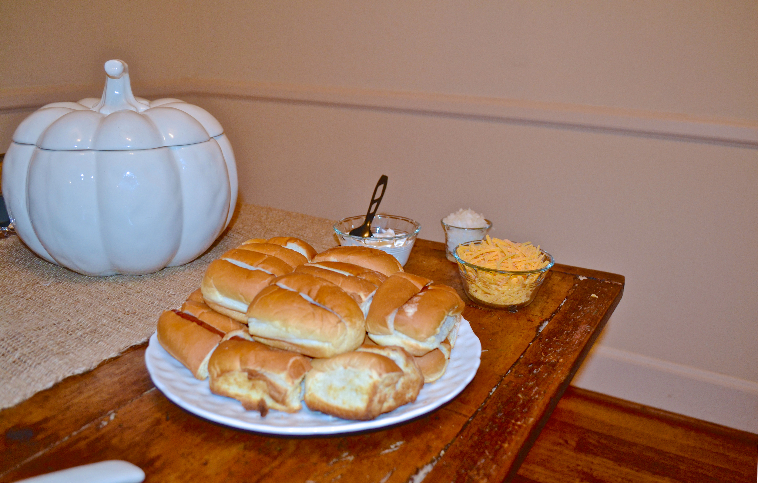 pictured: mini hot dogs, baked potatoes (in white pumpkin), and toppings
