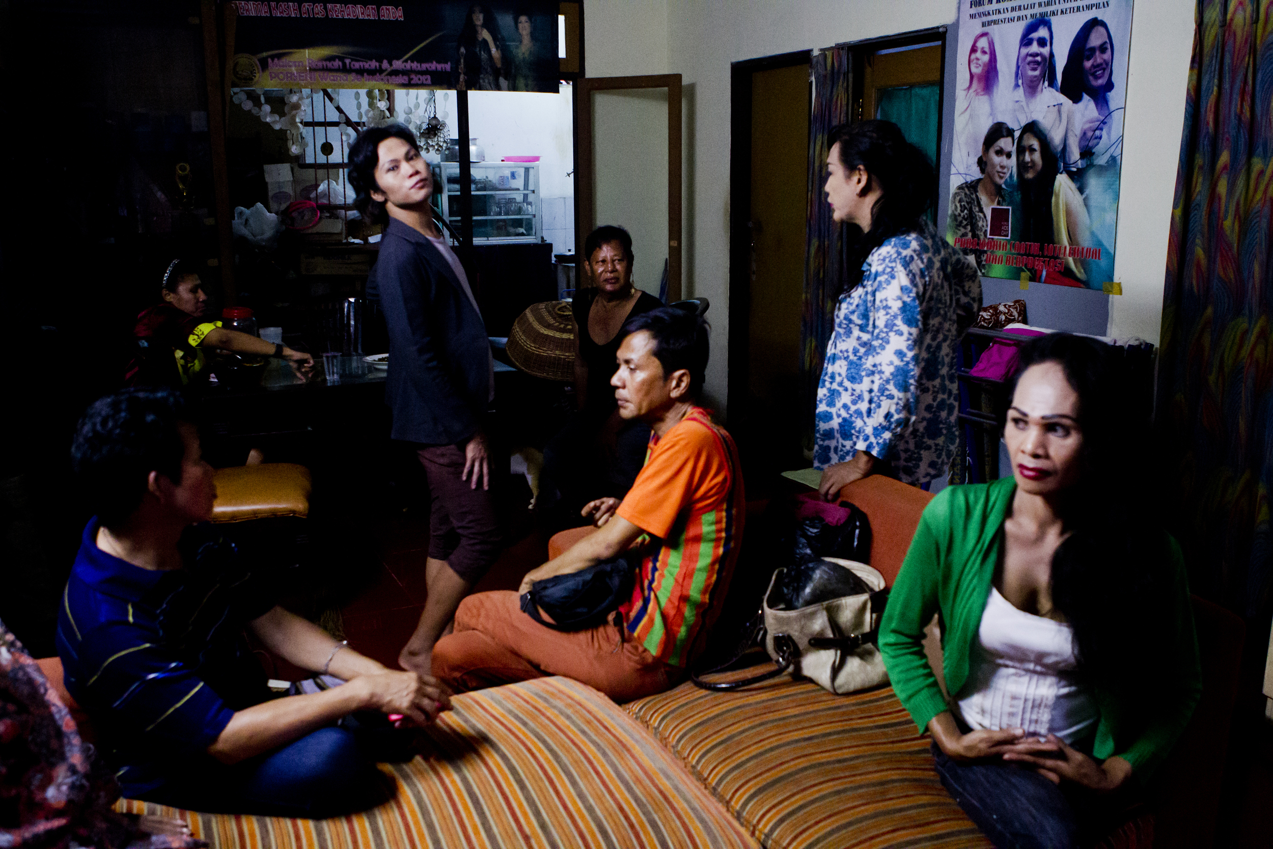 The pain inflicted upon them by an unwelcoming society does not stop many warias from building their own communities and working together toward the dream of an Indonesia that accepts and embraces their existence. Caption: A group of warias gather at Mami Yuli's waria safehouse outside of Jakarta. The community looks out for one another, the old for the young and vice versa.