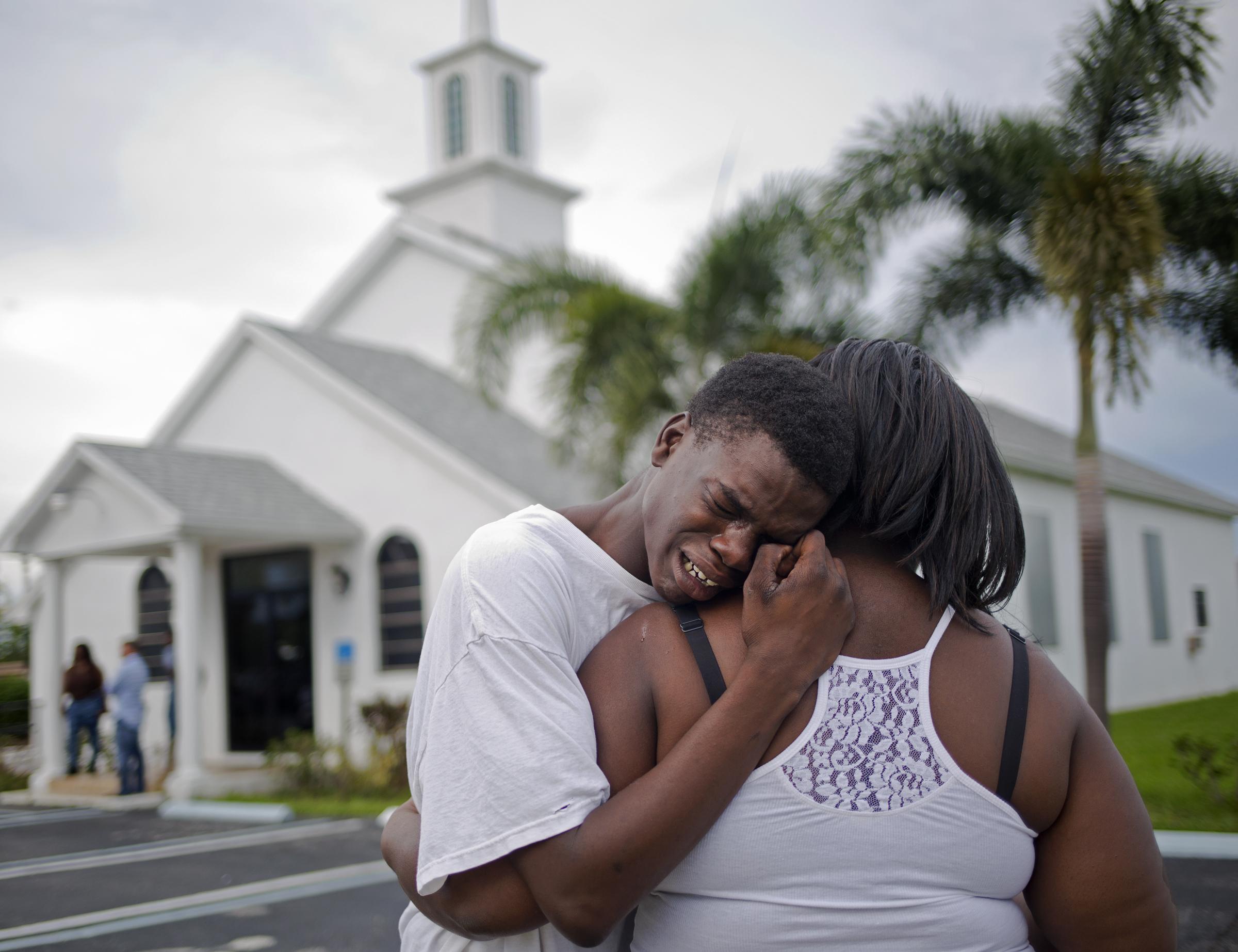 Lawerence Alston, 17, cries on the shoulder of a friend during the wake of his best friend Johnny Taylor Davis Jr. who was killed in a drive-by shooting in his North West Palm Beach neighborhood. Davis' neighborhood, which is just a few miles away from Trump's winter home Mar-a-Lago, was ravaged by gun violence over the summer of 2015. Overall, ten people were killed at 28 were wounded. 