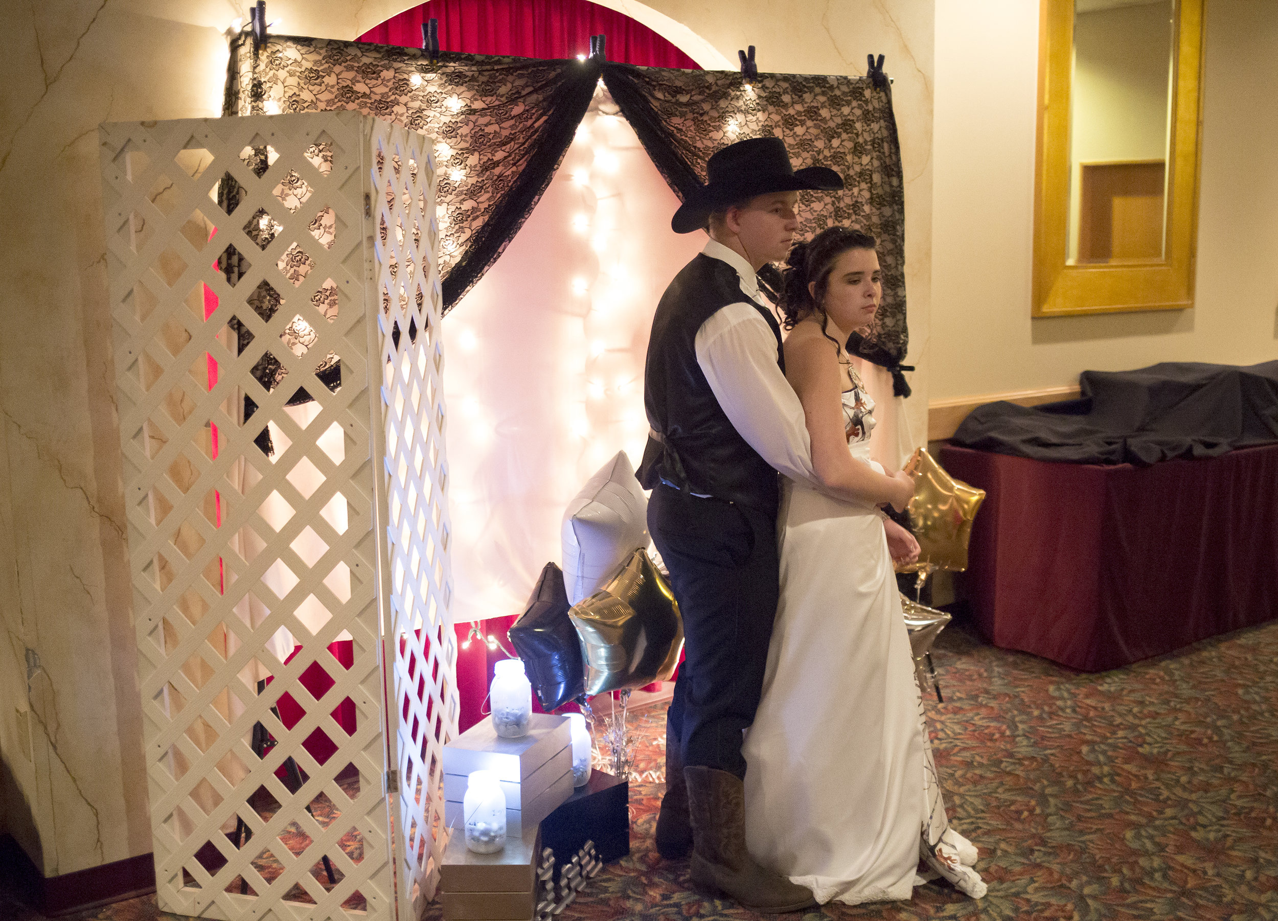Kiara Pinkham, 17, and her boyfriend, Drake McKenney, 16, pose for a portrait in the photo booth at Carrabec High School's prom in Skowhegan, Maine.