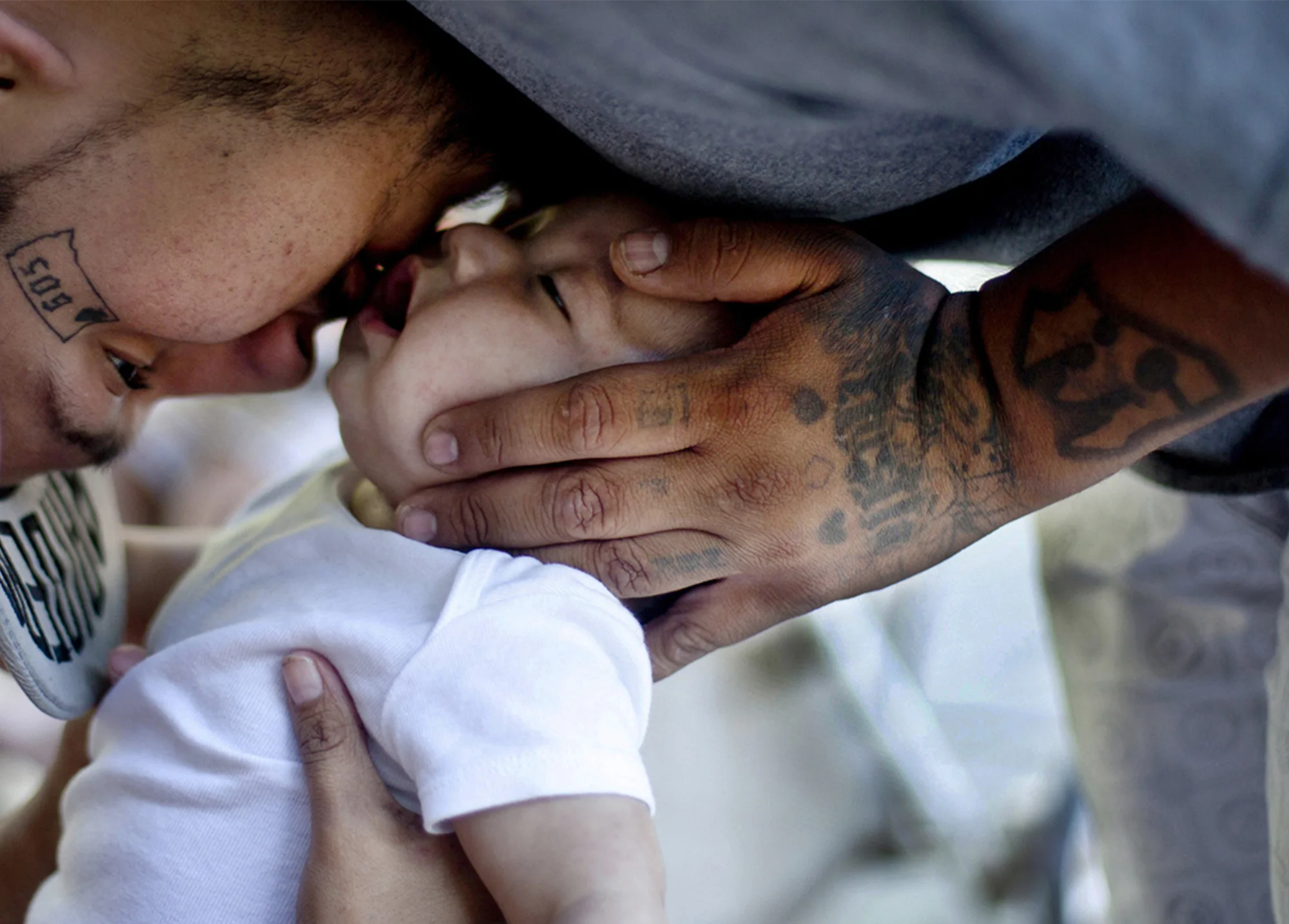 A father kisses his newborn. Rosebud.