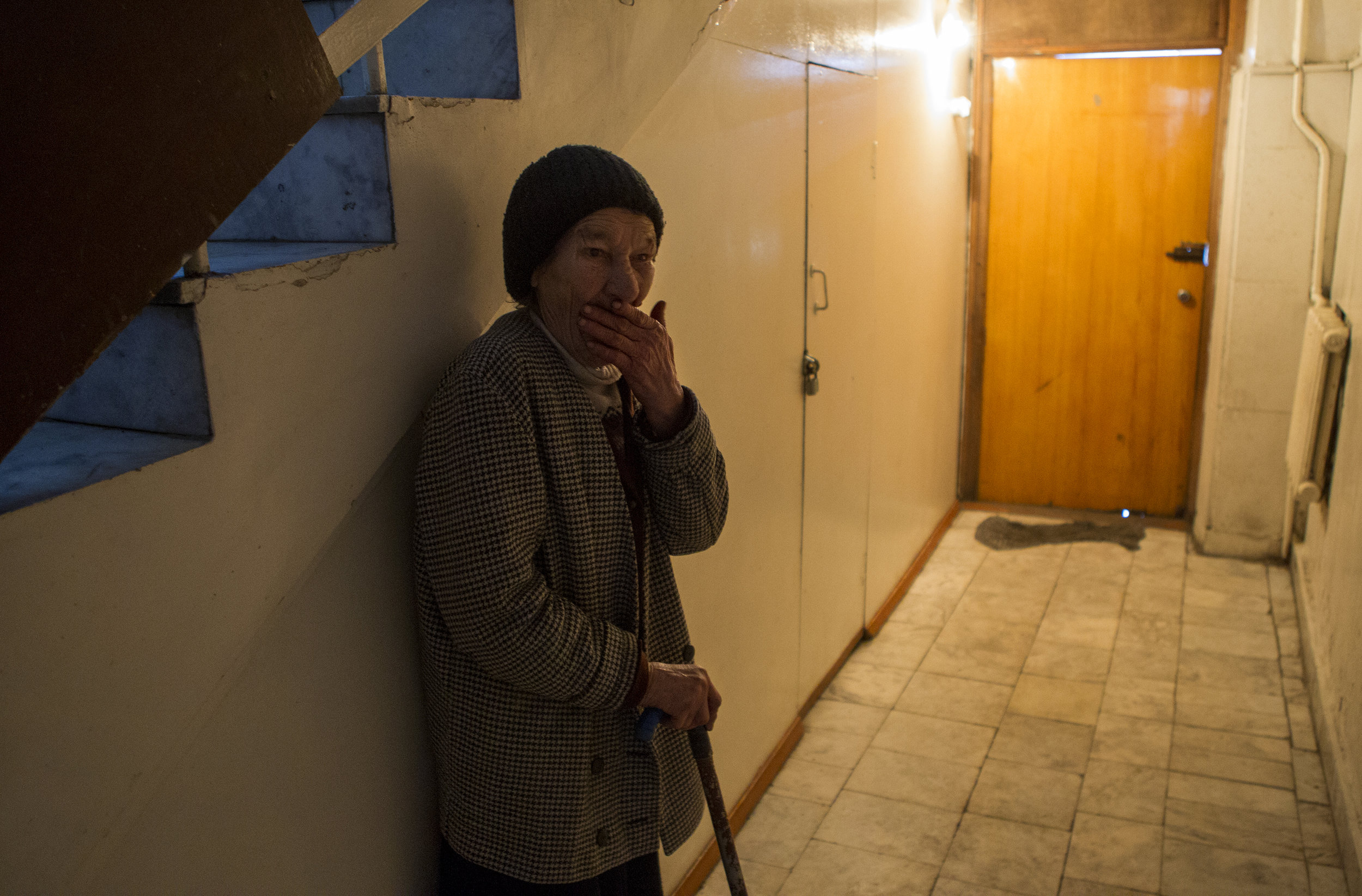 Tatiana Gerasimova, a blind homeless woman, stands in the hallway after lunch at the Kolotomto shelter in Bishkek. The Kolotomto shelter is one of the few places that the homeless can go for help in Bishkek.