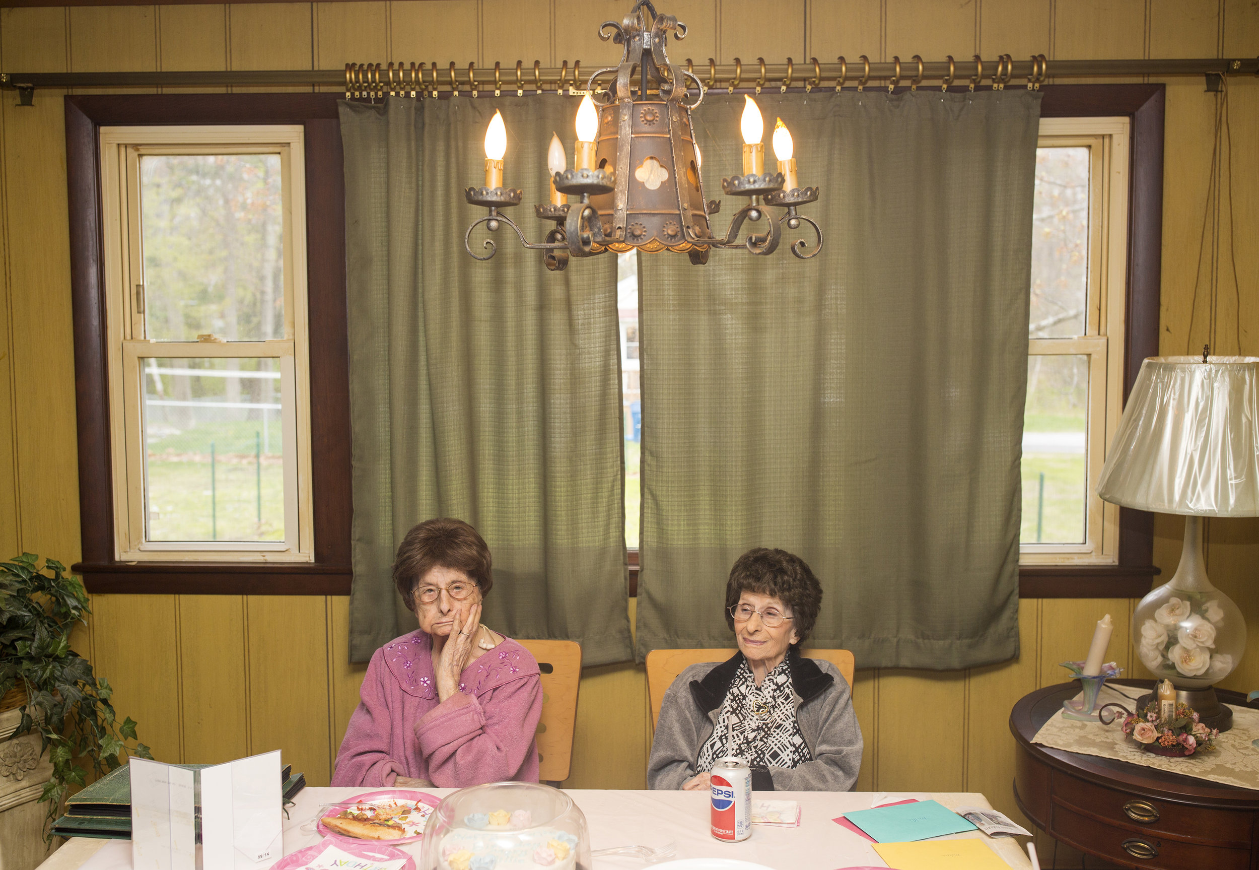 Identical twins Mary McCarthy, left, and Amelia “Millie” Lane celebrate their 100th birthday with their children and grandchildren at Mary’s home in Portland, Maine.