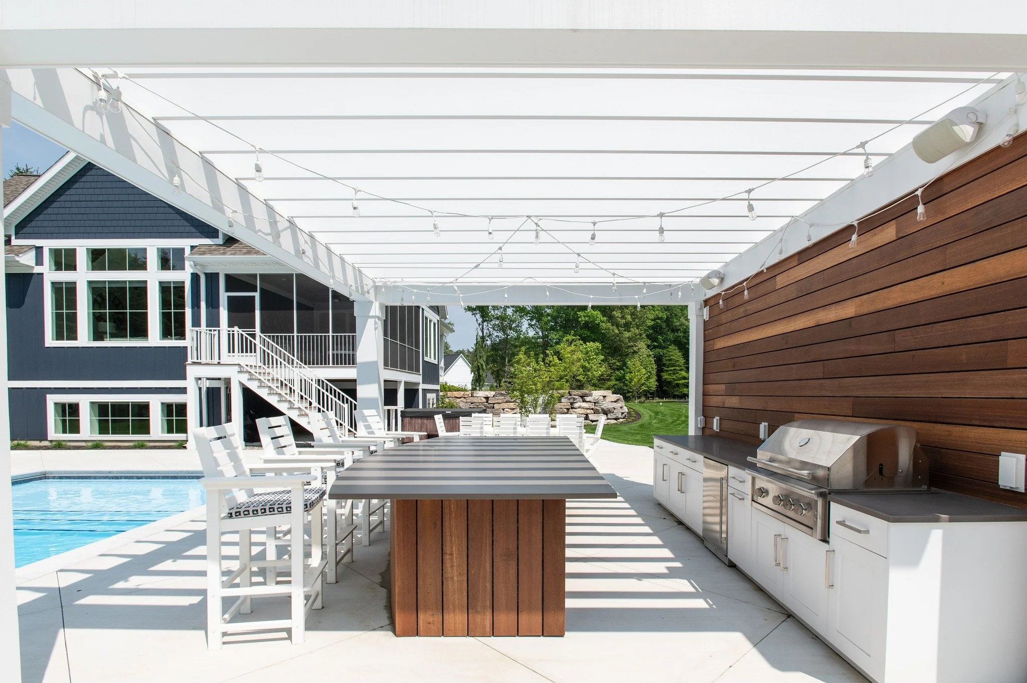 Outdoor living, elevated.

This custom outdoor kitchen showcases the beauty, craftsmanship, and durability that define every Benchmark Wood Studio project. Crafted from Accoya wood, this space is designed to withstand the elements while maintaining i