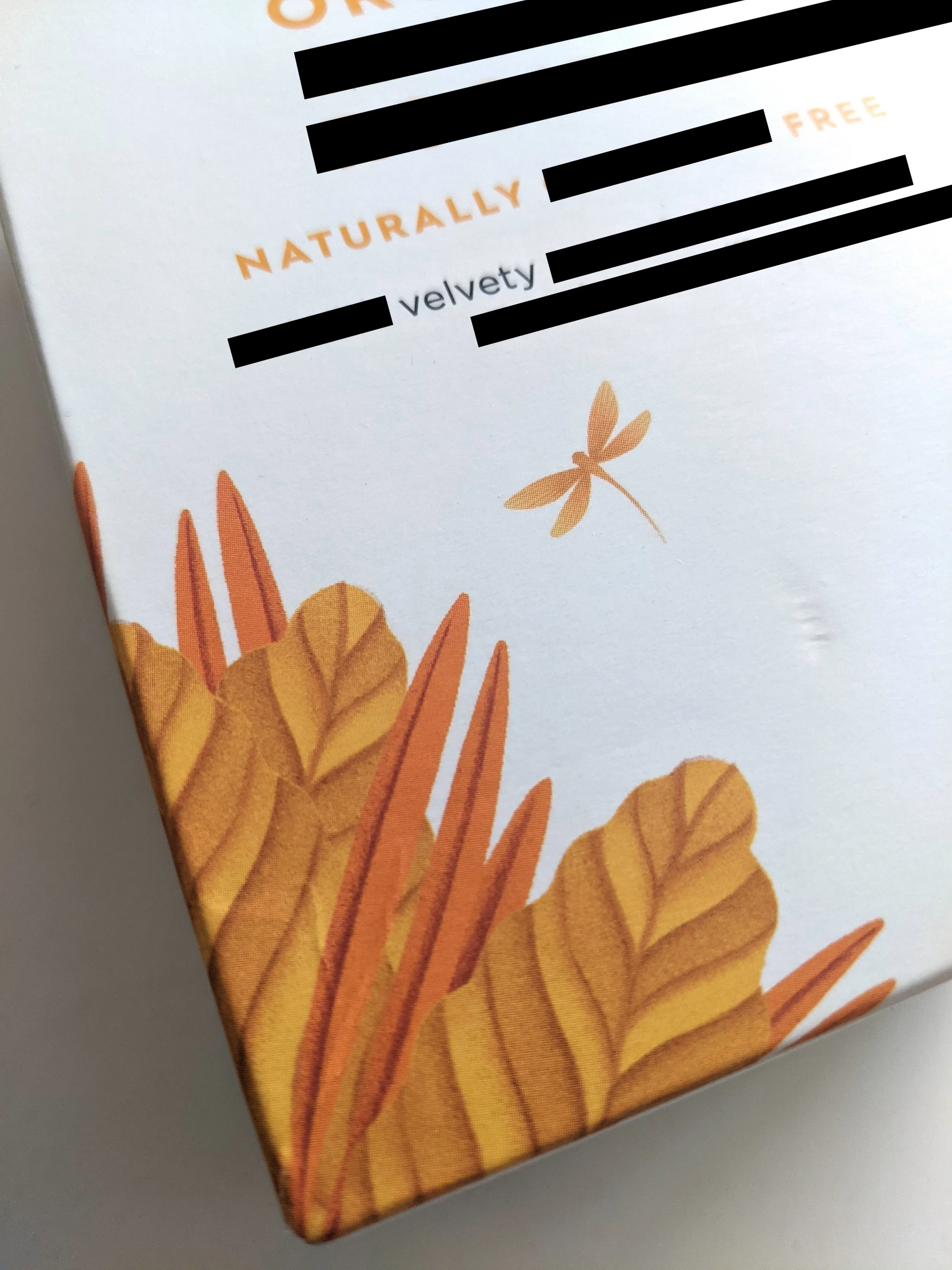 tea box with dragonfly and plant illustration, emphasis to words NATURALLY VELVETY FREE