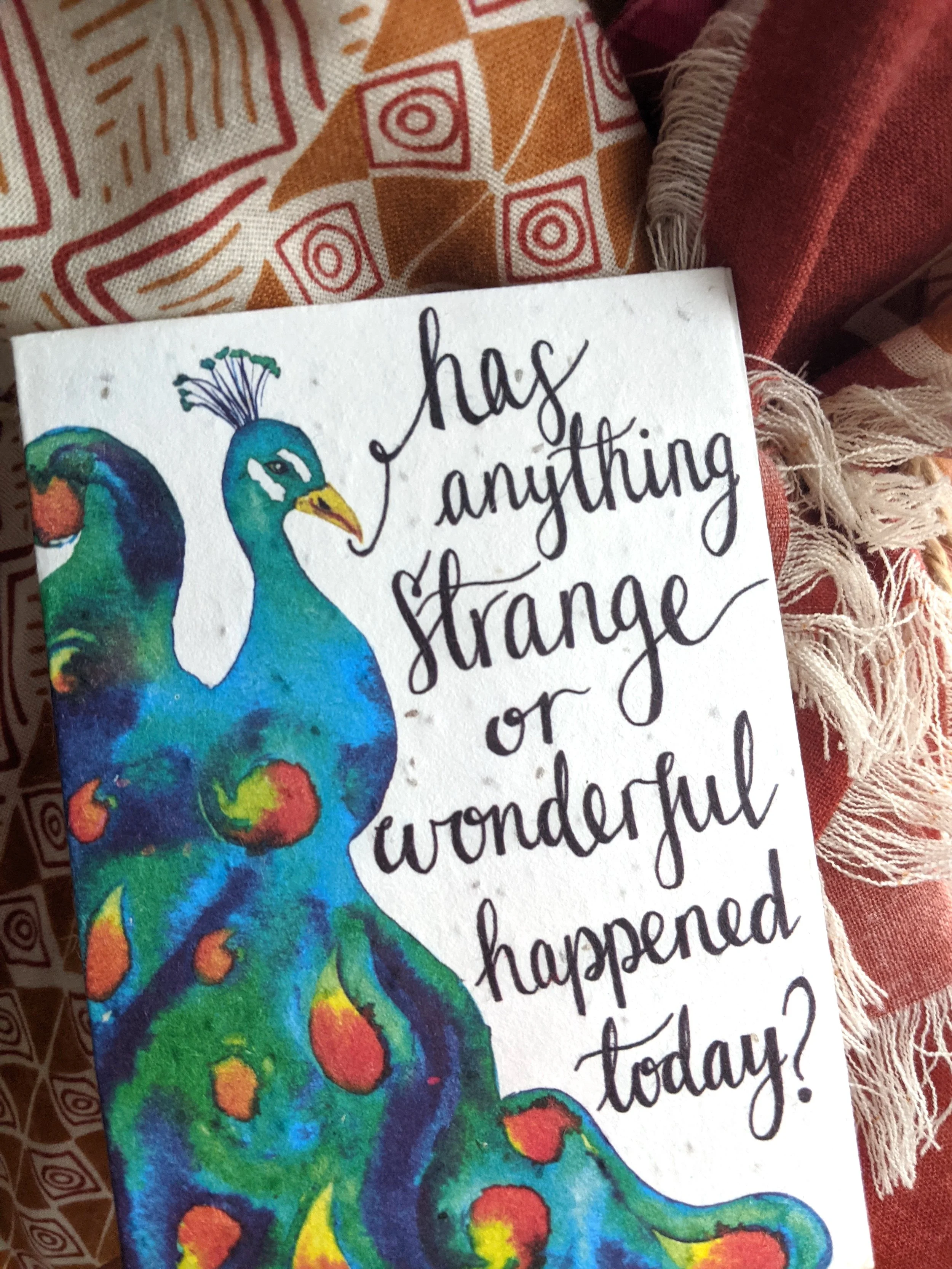card with peacock illustration and question "has anything strange or wonderful happened today?"