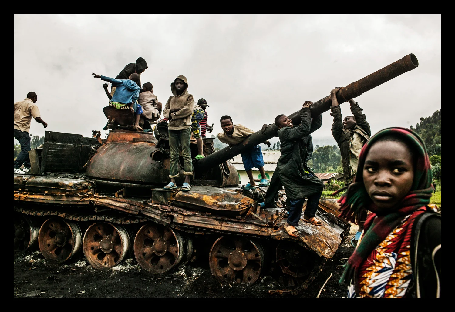 Children play on a destroyed tank