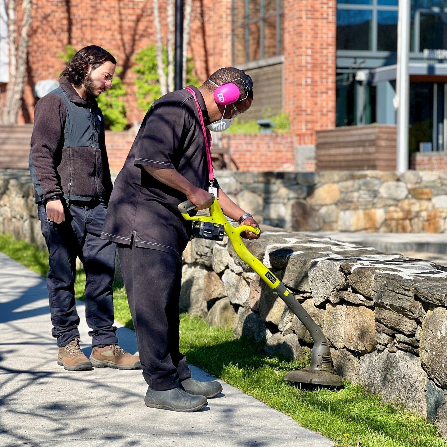 Welcoming in May with landscaping work! Sparkle on, MC Dan and Adam! 🌱🌸✨ ⁠
.⁠
.⁠
.⁠
.⁠
.⁠
Photo caption: 1. Adam supervises MC Dan as he uses a weed whacker to trim grass along a stone wall. 2. MC Dan mows the lawn outside of the Theater. #SparkleO