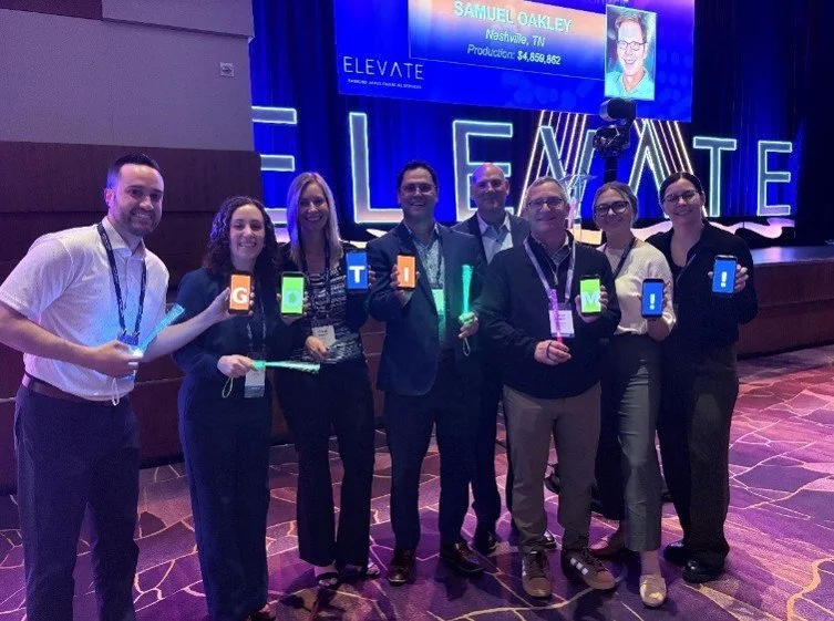 Center team celebrates Tim Wyman for hosting Raymond James' Elevate Conference panel.