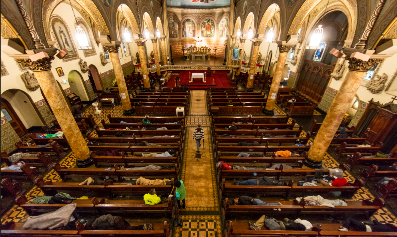 Homeless people sleep in the pews at St Boniface Catholic Church as part of the Gubbio Project Photograph: David Levene for the Guardian