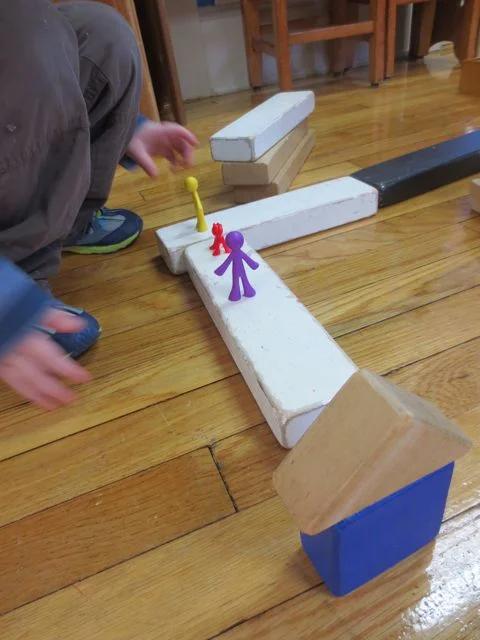 I noted that there was a change in the way the children created landmarks, both on paper and in their constructions. In this photo, you can see that the landmark: School is standing upright and also the children-figures are walking ON the path rather than alongside. This is a marked change in approach.