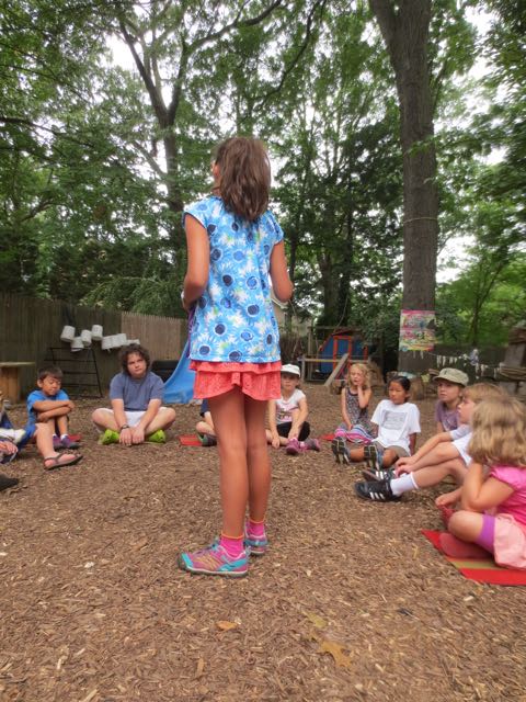 It’s her turn now. One of the Tink campers teaches the other children how to play a game she knows called “All my friends and all my neighbors”