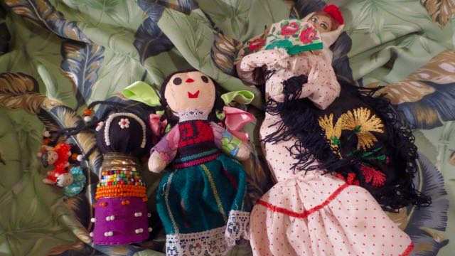 A collection of dolls. Nancy had noticed early on that we have a collection of dolls that the children play with. Each one is more special than the last. All of them resting on a large piece of feather fabric.