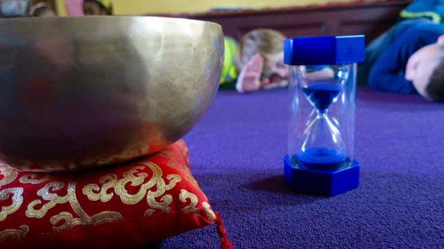 The singing bowl and the five-minute timer. Heart, hand, settle. Breathe.