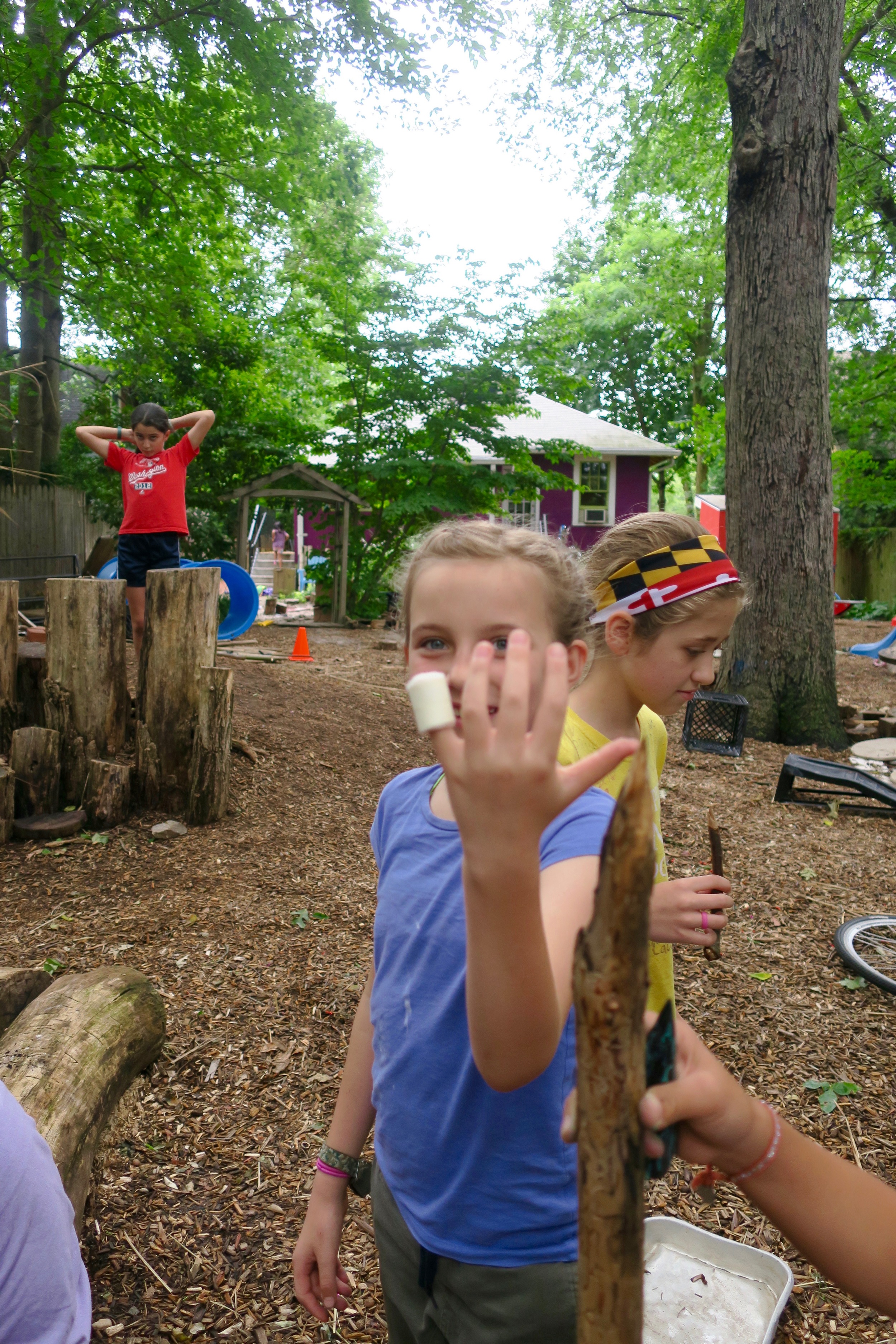 A whittling injury. She is especially happy that the bandage looks like a marshmallow.