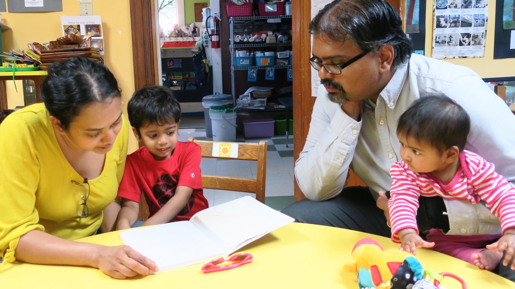 Parents review their child's journal, artwork, and portfolio. There are many check-ins, from weekly class updates, weekly co-oping, and parent trainings , to portfolio conferences led by the children.