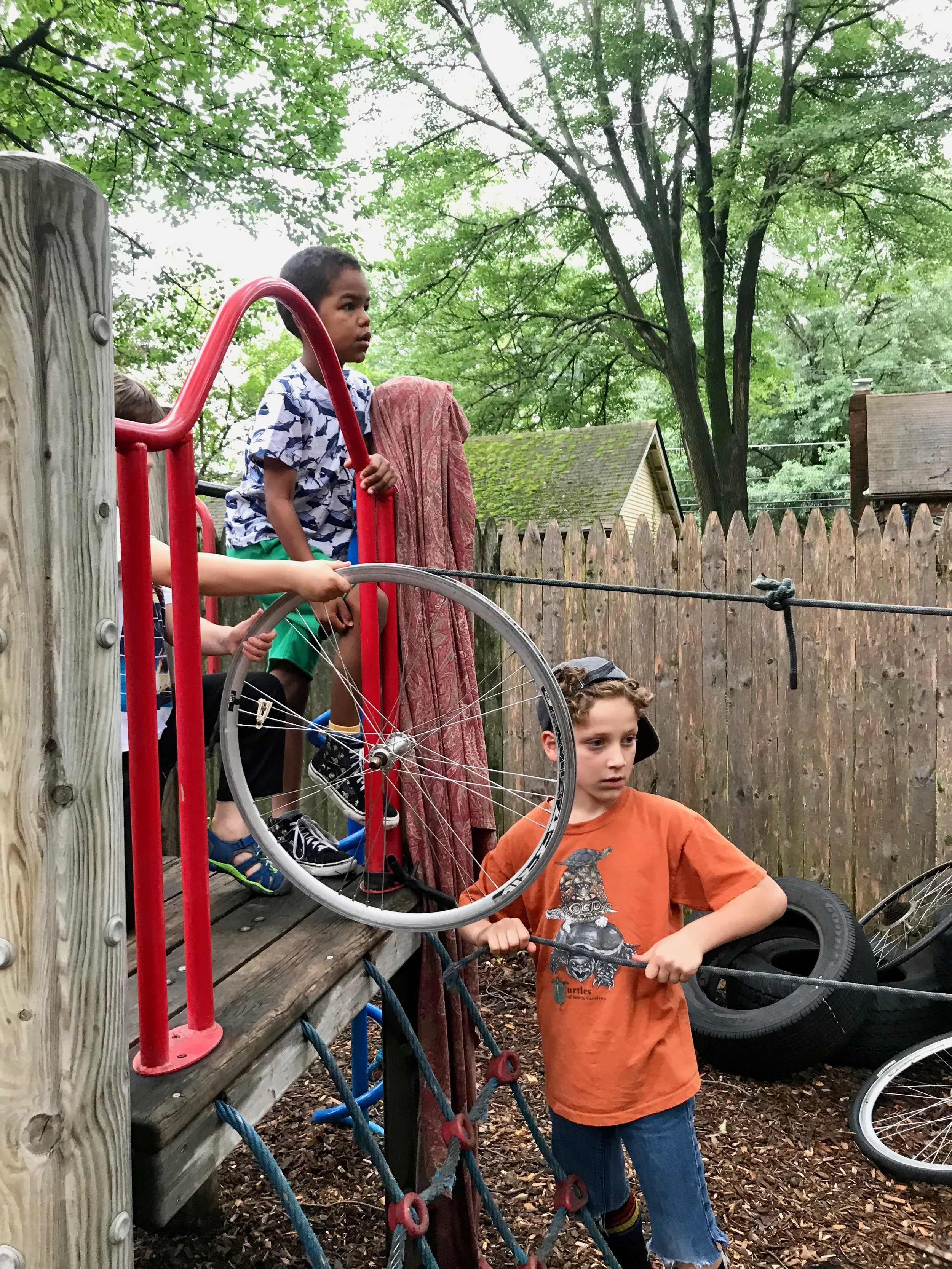 The campers could see that this rope and bicycle wheel combination resembled a pulley system. This spoke to them, but they were met with so many hurdles. They couldn't find a single length of rope, they couldn't pull the ropes taut, and they couldn't figure out how to move something along the length of the zip line.