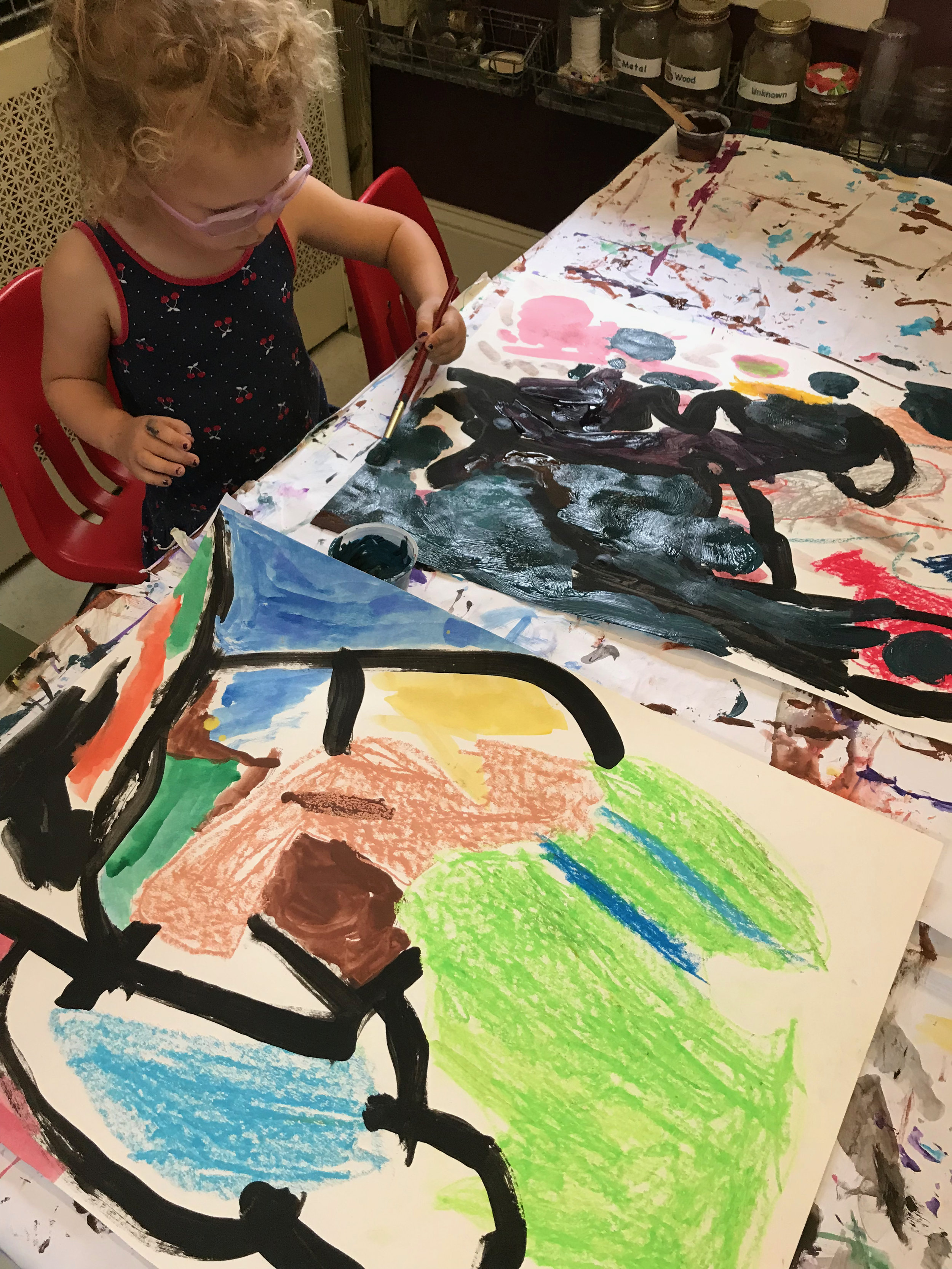 Two artists applying “nighttime” shades of paint to their backgrounds.