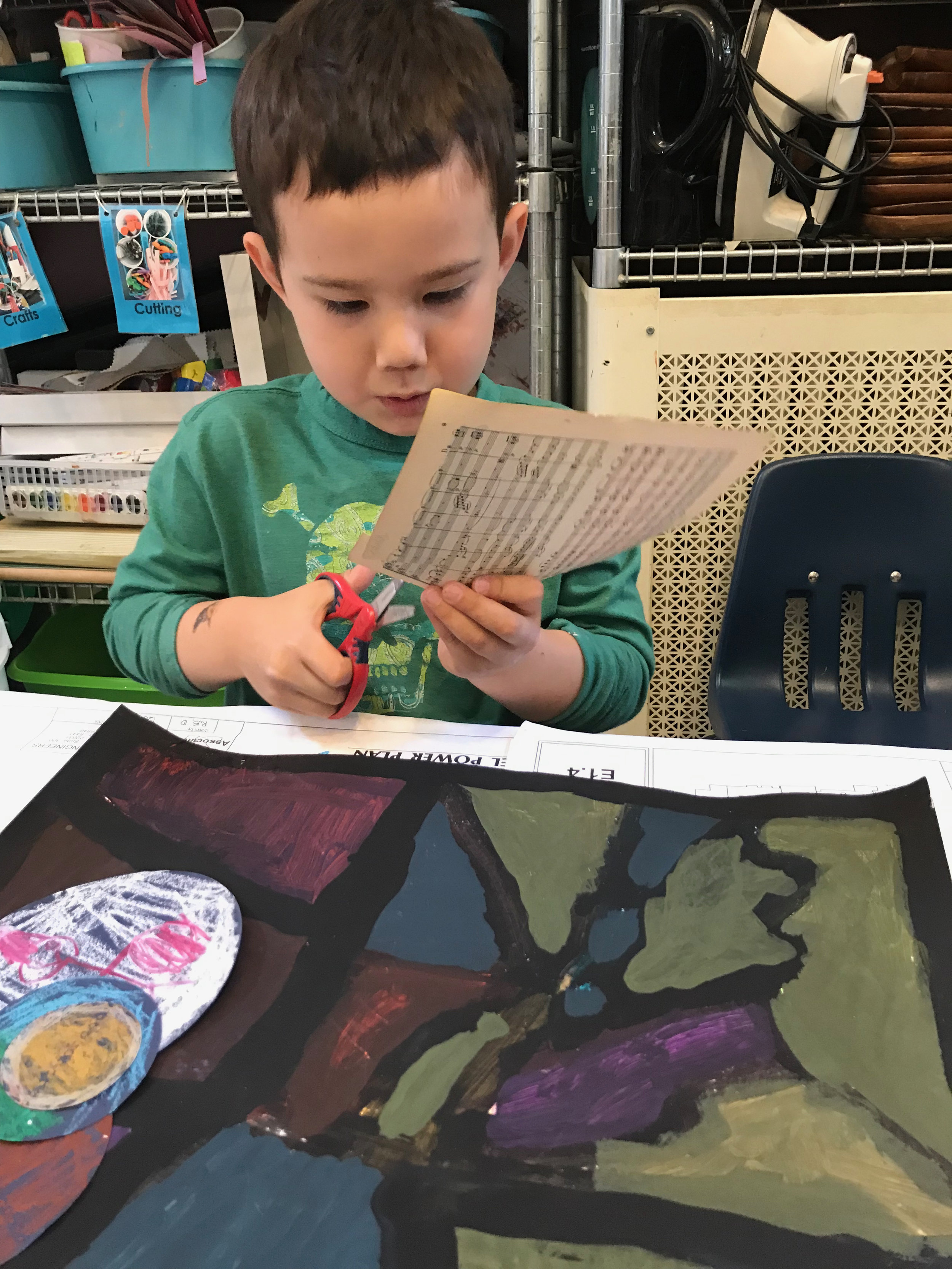 Cutting the watercolor music sheets into smaller squares and rectangles. These are attached along the black lines. This lesson of valuing the layers — all that work that has gone before — means that the children experience art in a completely different way.