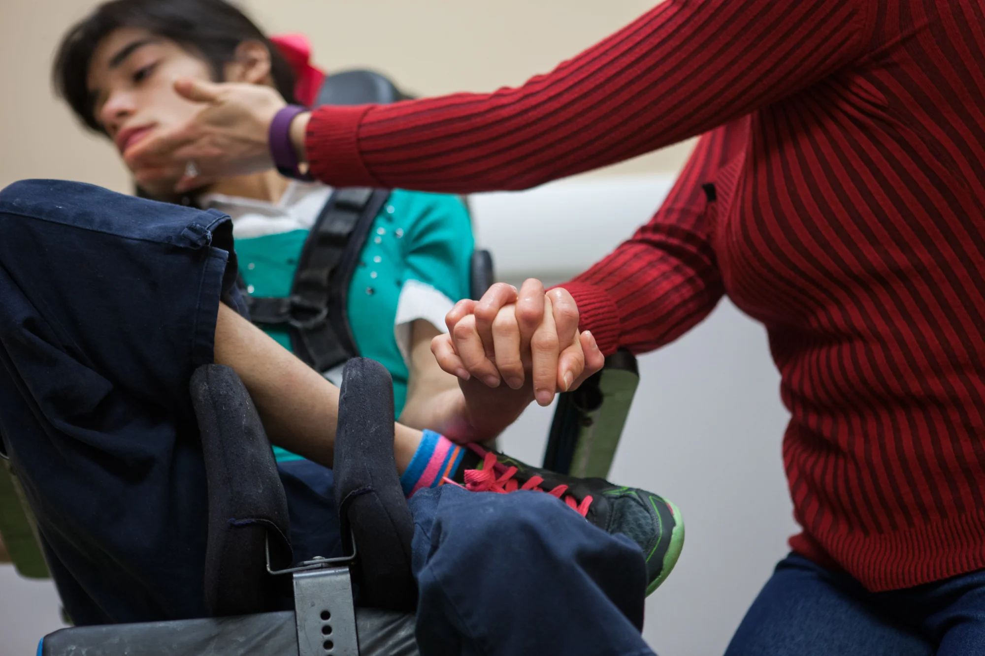 Jordyn and her mom Vanessa Castro interlock fingers during a visit to Cook Children’s Hospital’s neurology clinic for a checkup with Dr. Perry, the lead physician on a drug study studying a seizure medication derived from cannabidiol, a non-psychoac