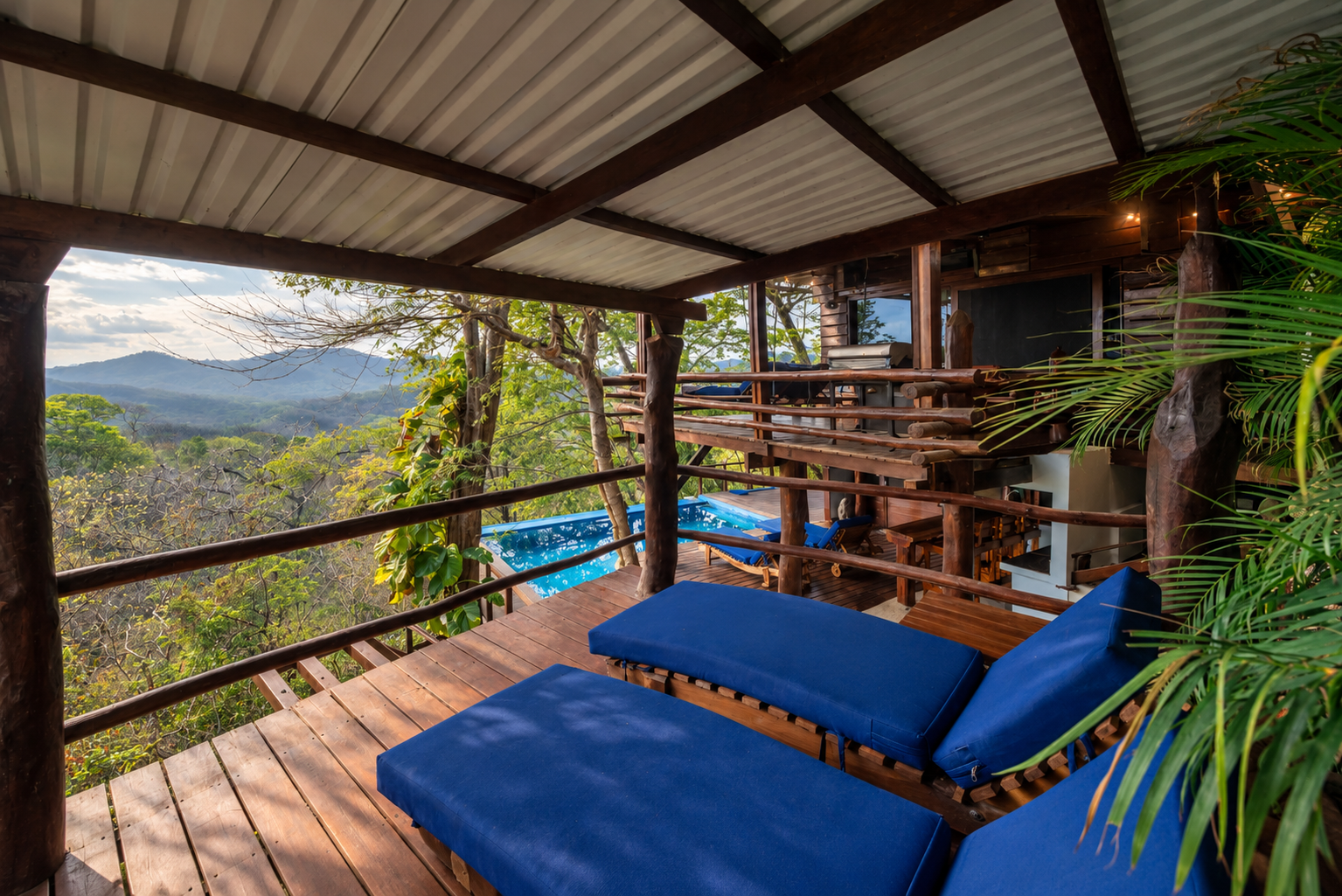 Tropical Lodge Deck Overlooking Misty Mountains.png
