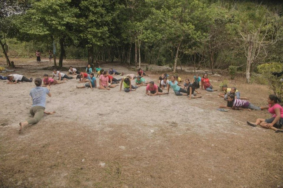 Daphne teaching yoga in the jungle of Guyana.
