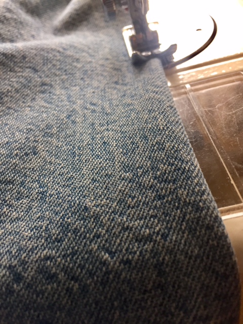 Place the folded jean leg under the sewing machine, allowing a small seam allowance go 3mm and sew straight down the fold. 