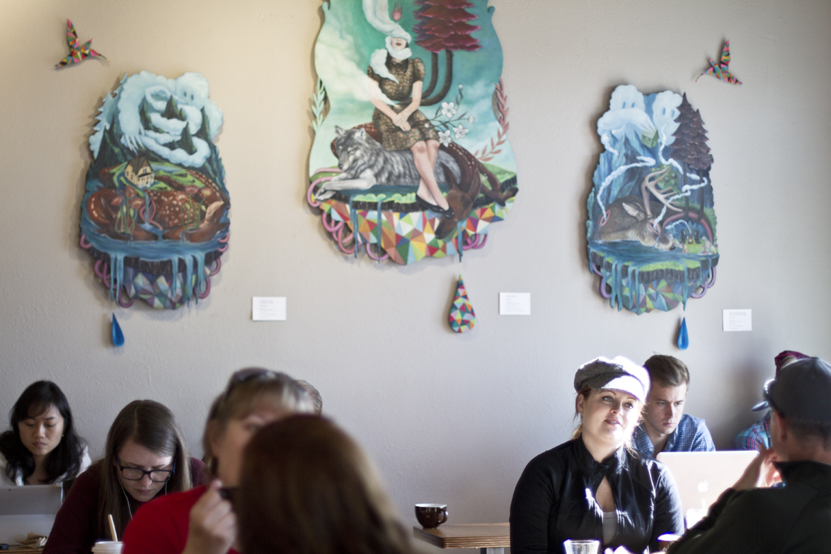 Inside Sunrise Coffee with artwork from local artist Su Limbert.