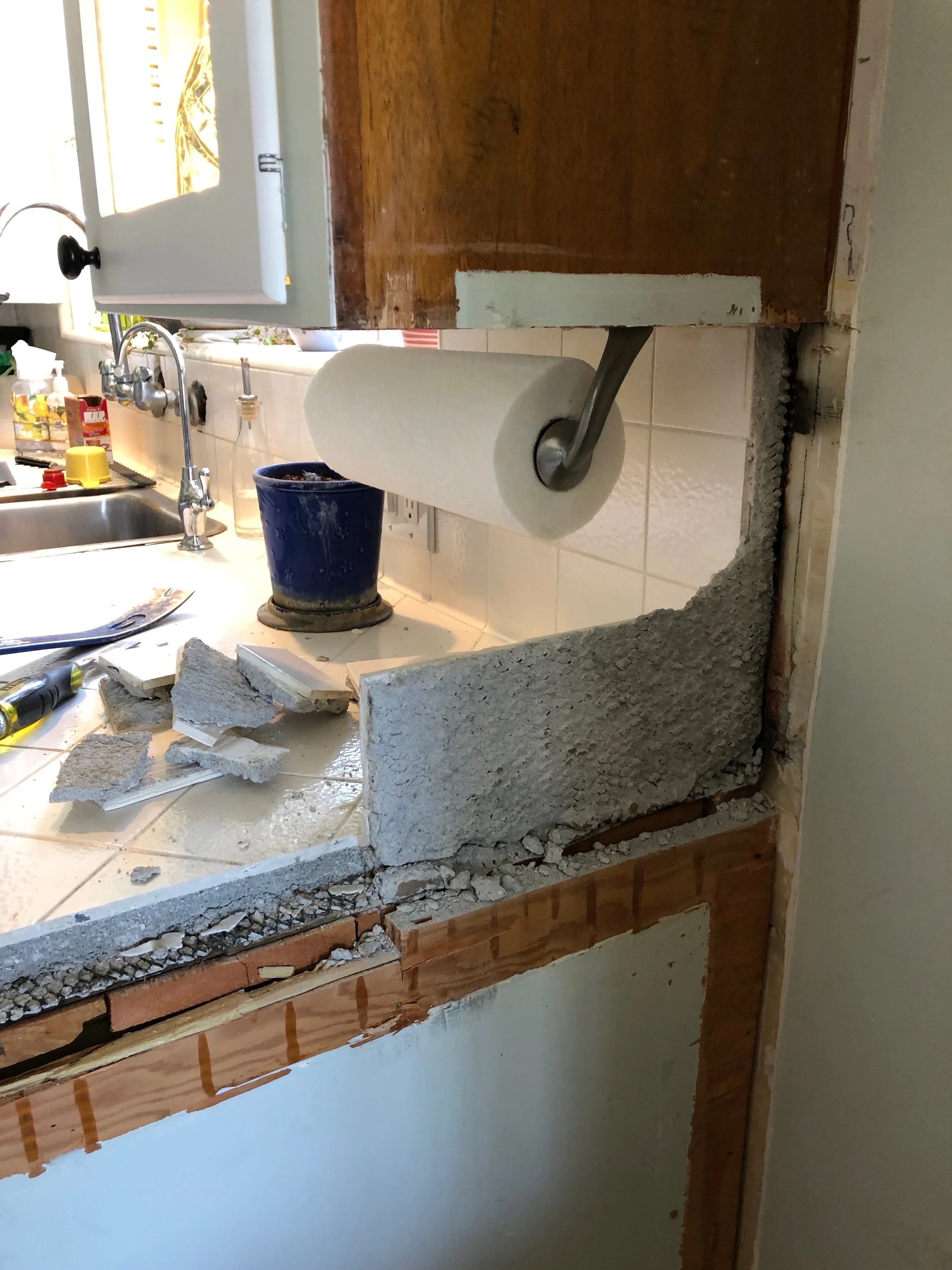 Removing the backsplash for extension of counter tops.