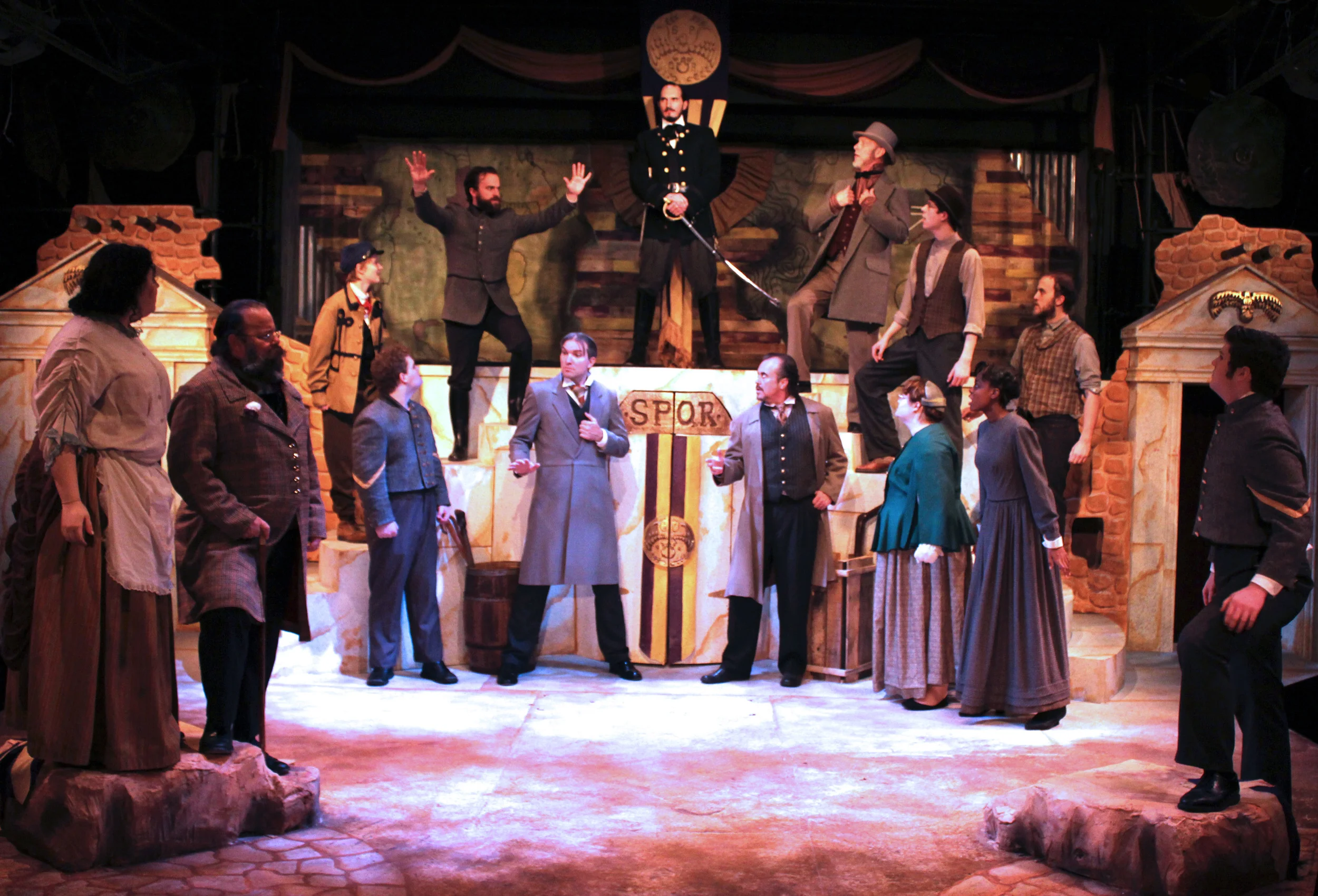 Front: Citizen (Chelsea Day), Sicinius (Dan Burke), Soldier (Brennan Watt), Senator (Charles Hooker), Brutus (Jeffrey Rensch), Citizen (Erin Eckert), Citizen (Kennedy Miller), Soldier (Chris Marth) Back: Citizen (Rose Weber), Cominius (Mark Sherlock), Coriolanus (Thomas Weaver), Menenius (Philip Wheeler), Citizen (Aidan Roth), Citizen (Collin Wilmarth)