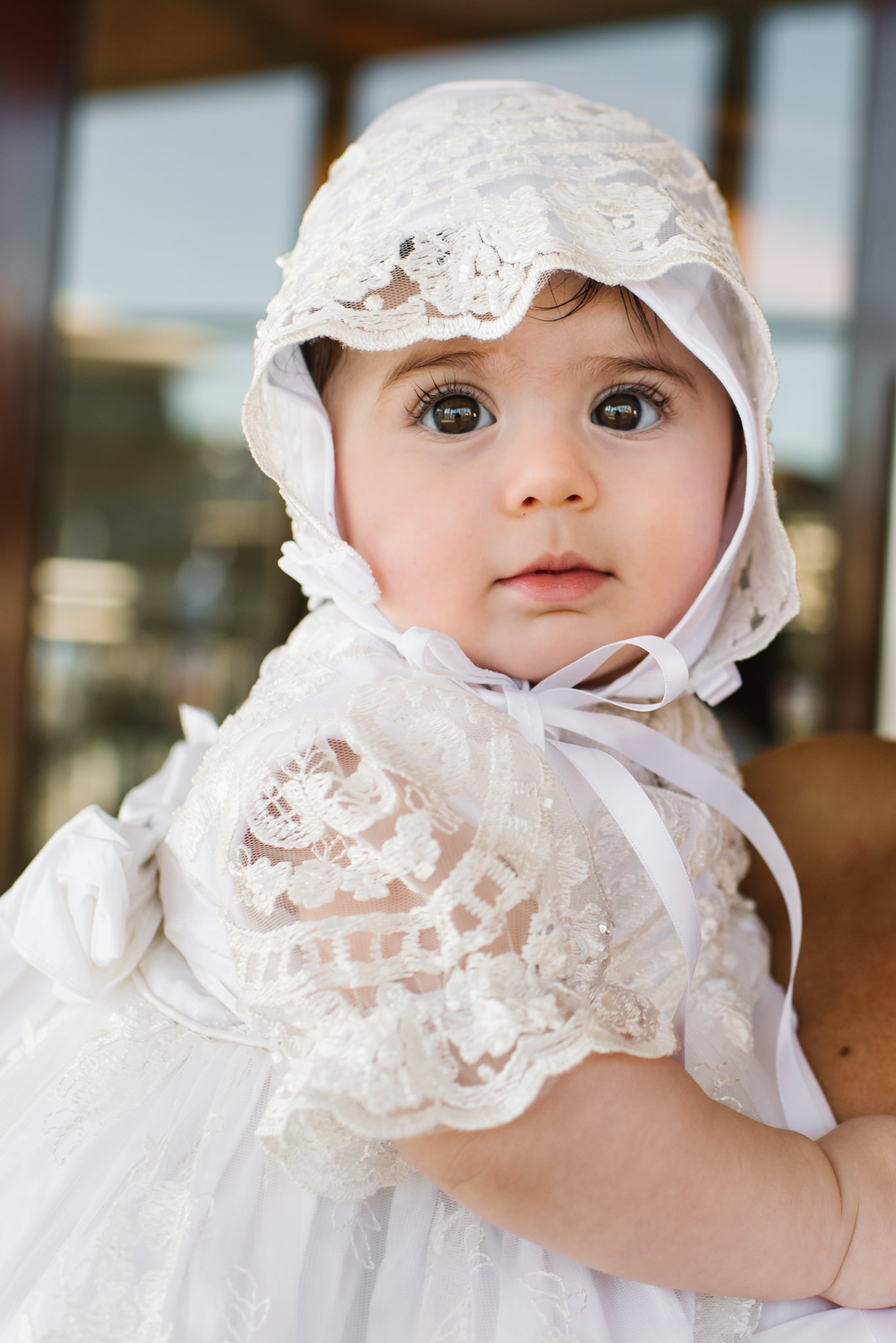 Baby in christening gown and bonnet