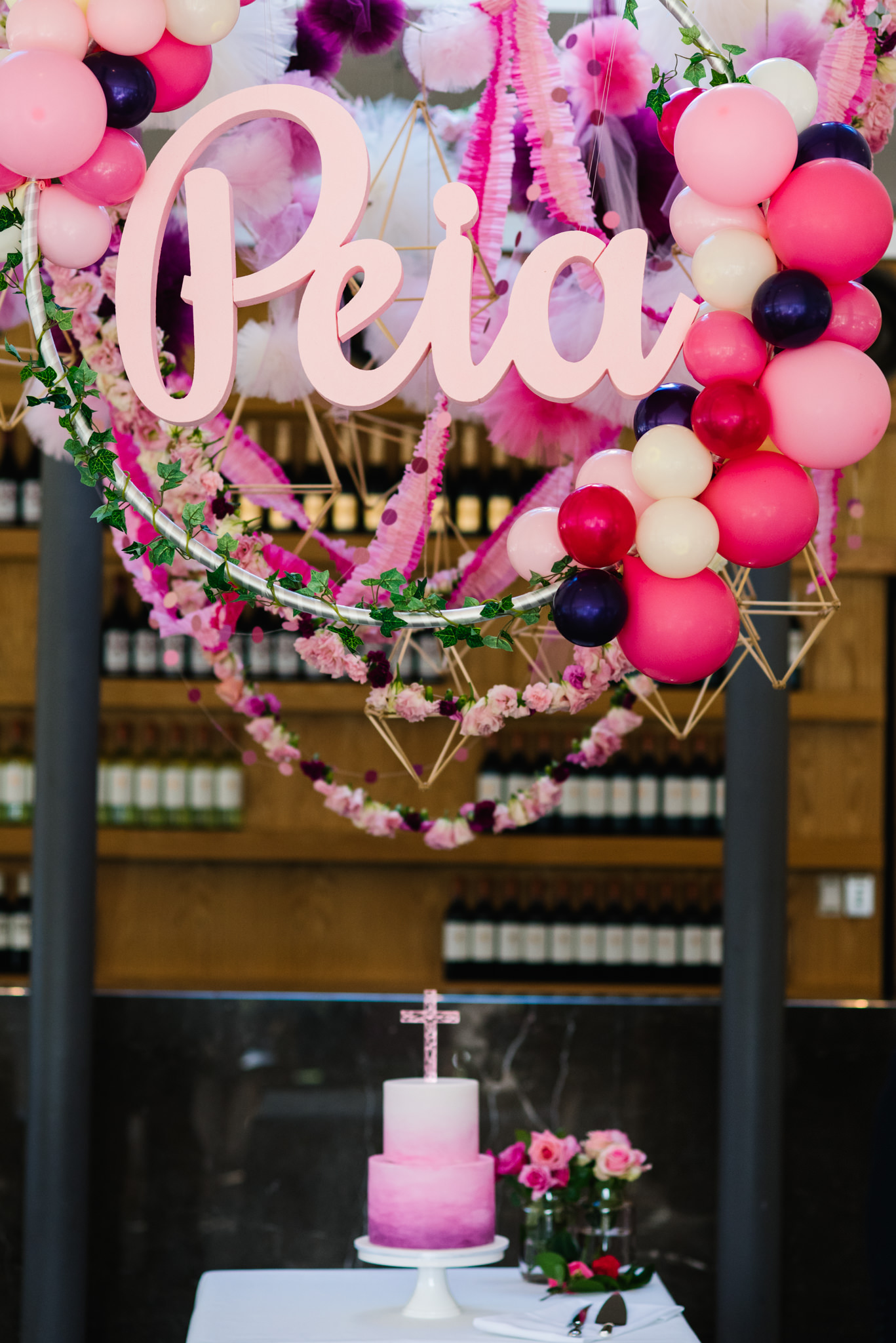Cake table with balloons and name sign