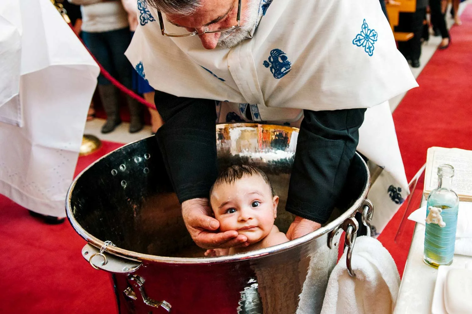 Baby in baptismal font at Gladesville Greek Orthodox Church