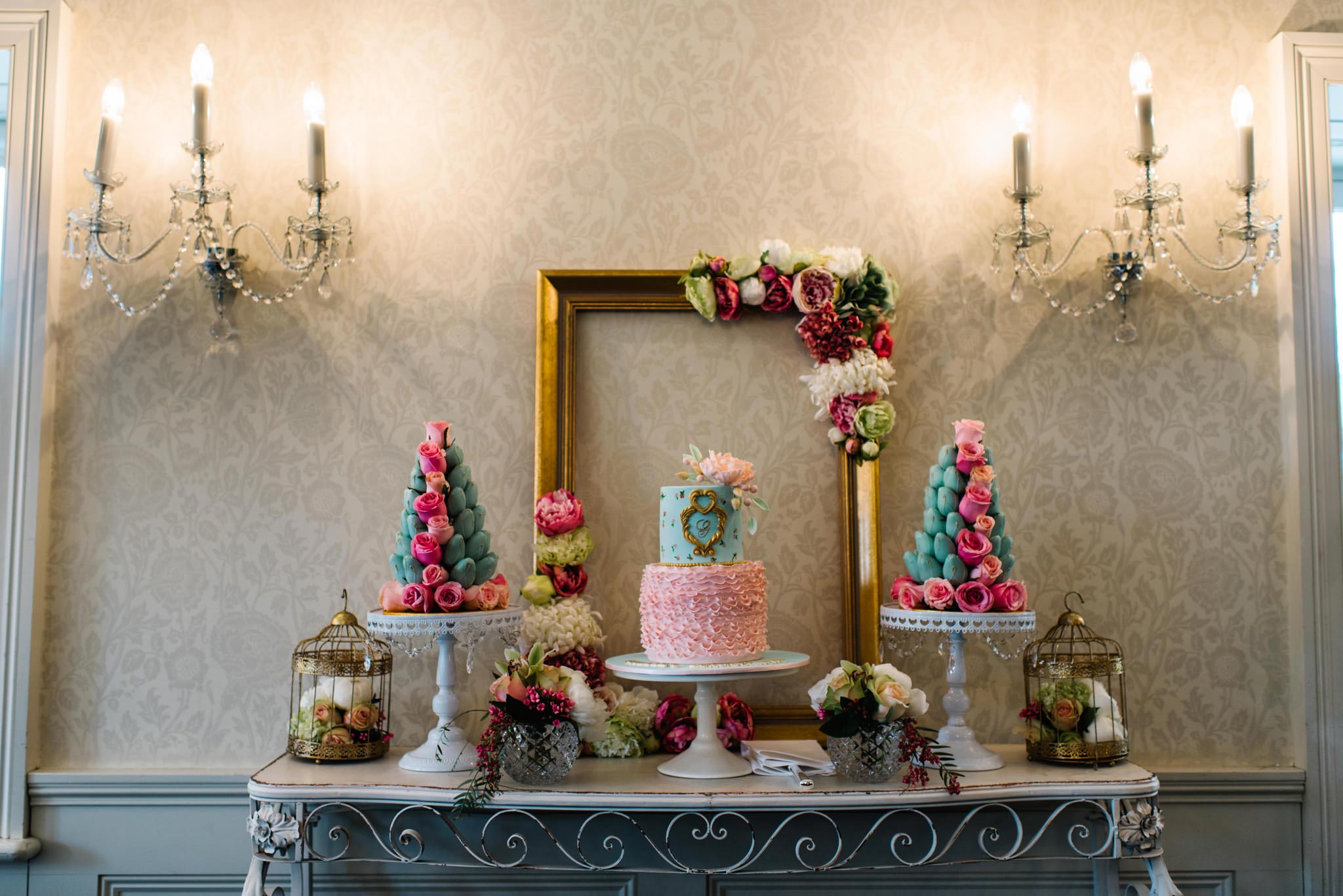 Cake table and decorative wall sconces at Dunbar House
