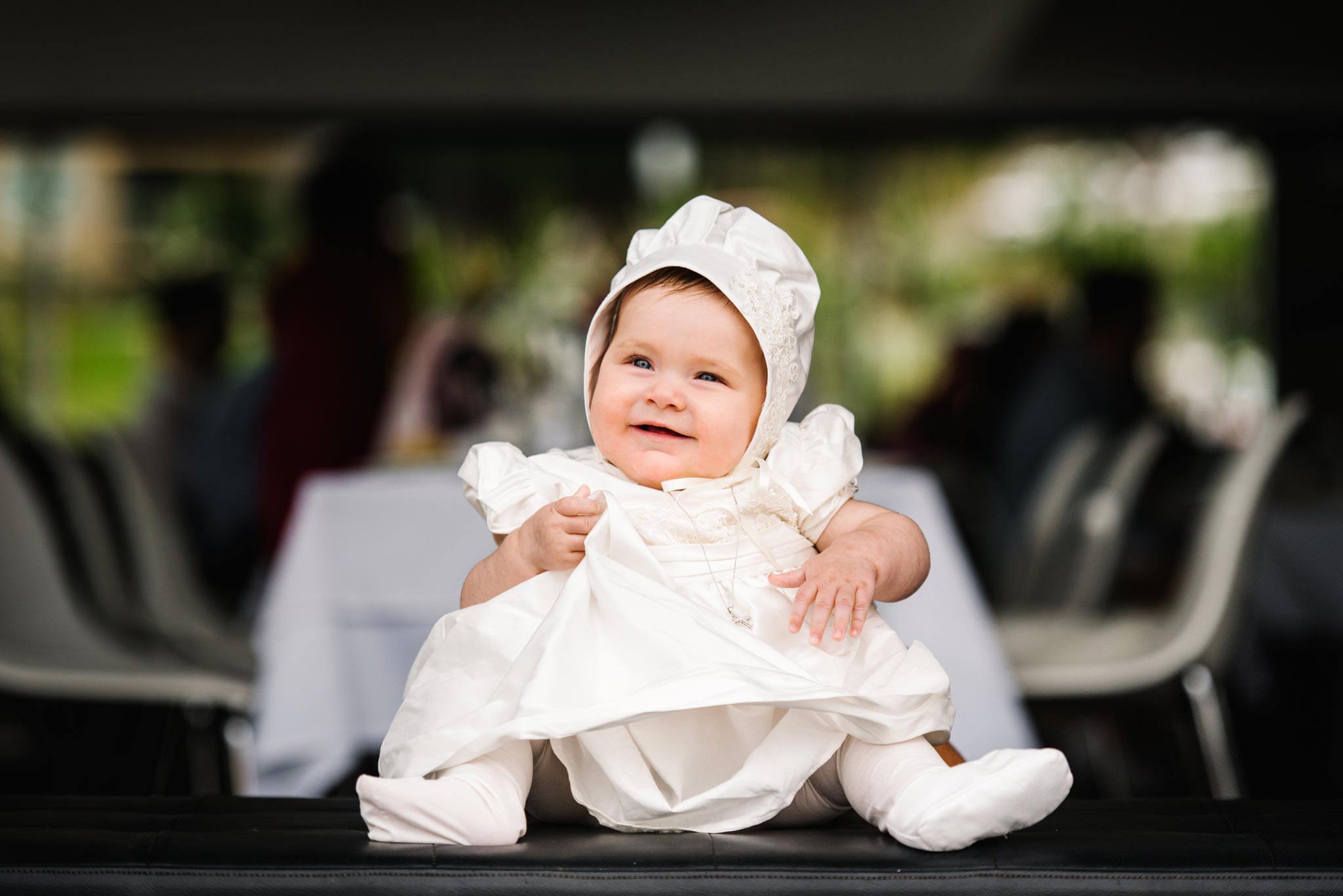 Baby in christening gown and bonnet at Ecco Drummoyne
