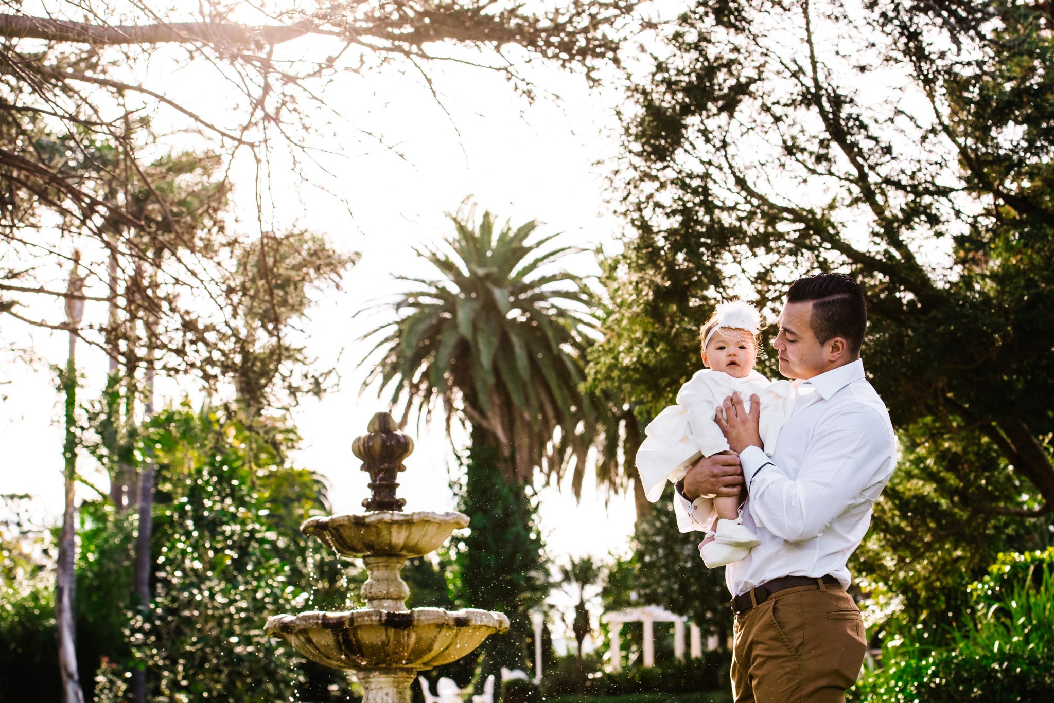Godfather and baby in front of fountain at Oatlands House