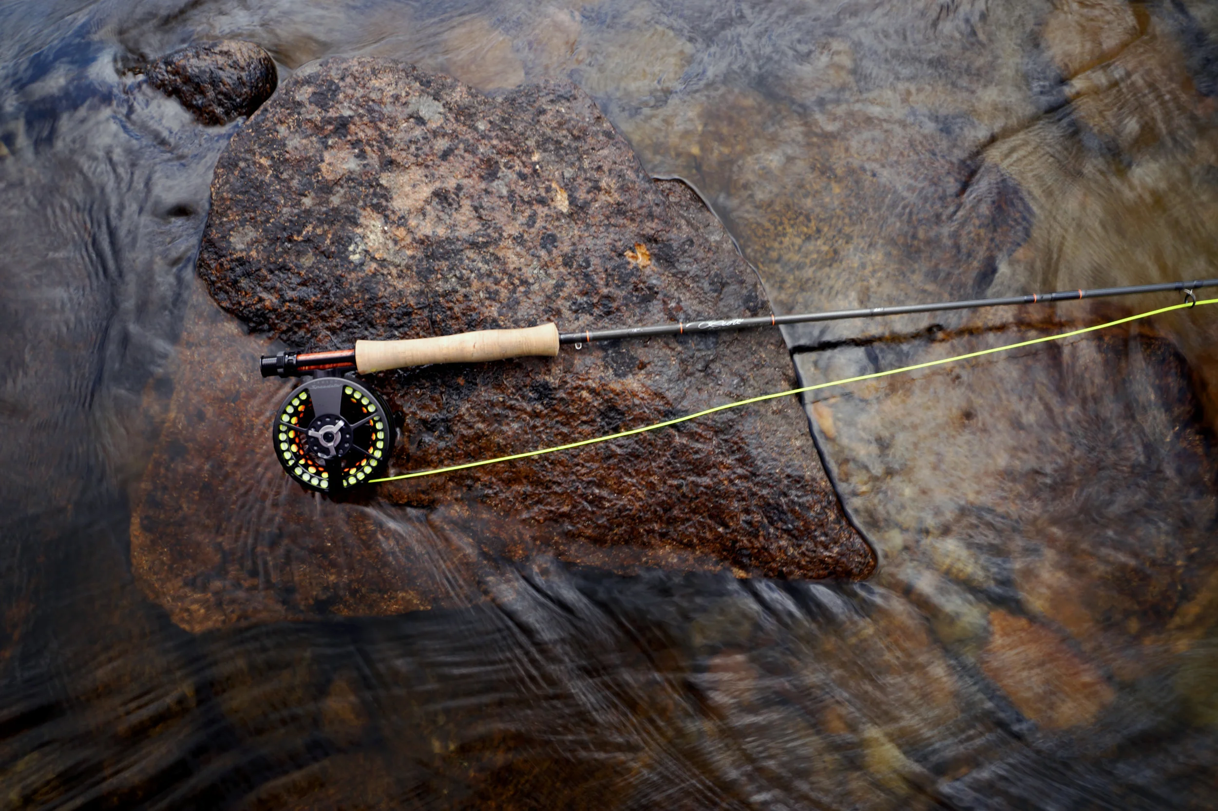 Fishing rod rests on rock in Thredbo River