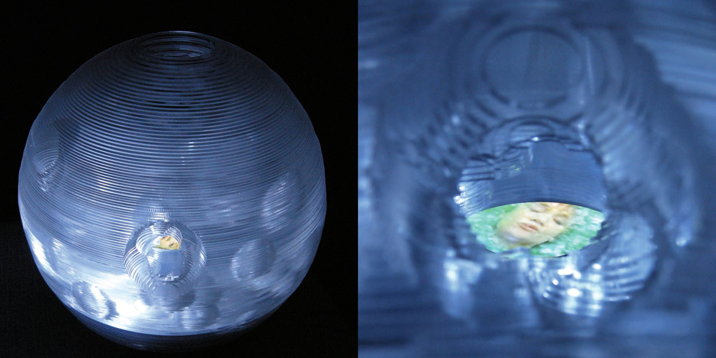 Miniverse 3 , 2009 Layered clear acrylic sphere 30 cm / 12 inches diameter. Video screen embedded 3:50min, looped.