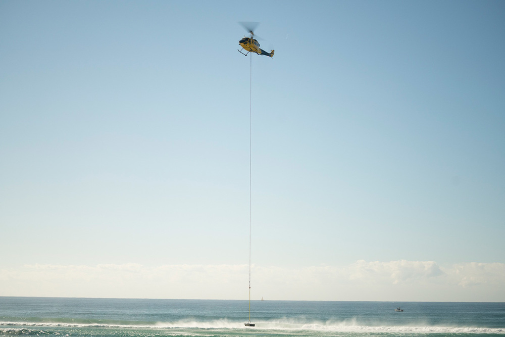 Helicopter lifts Aquarius Barrier at Lennox Head